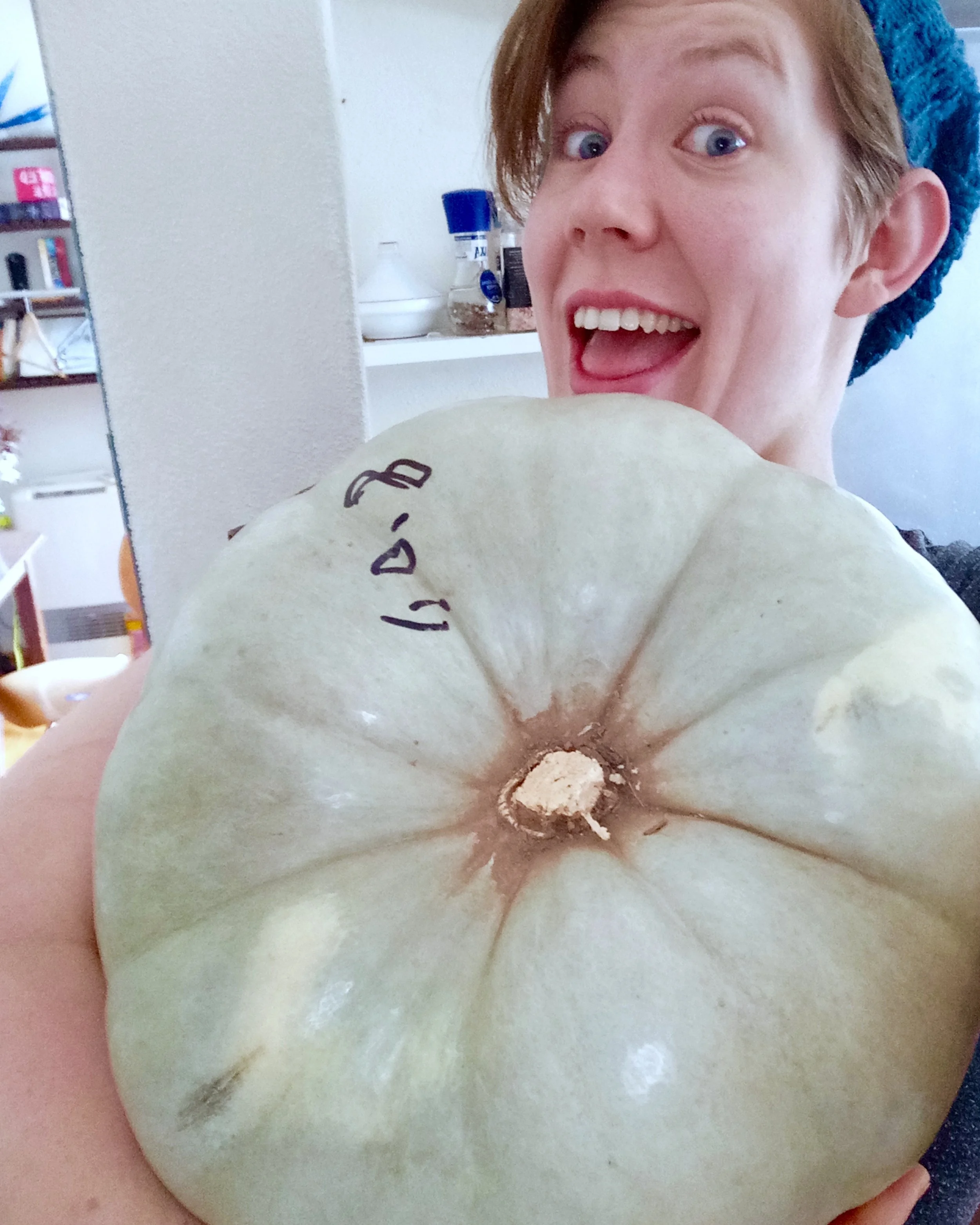 This should give you an idea of the size of our gargantuan pumpkin. My face for scale. 