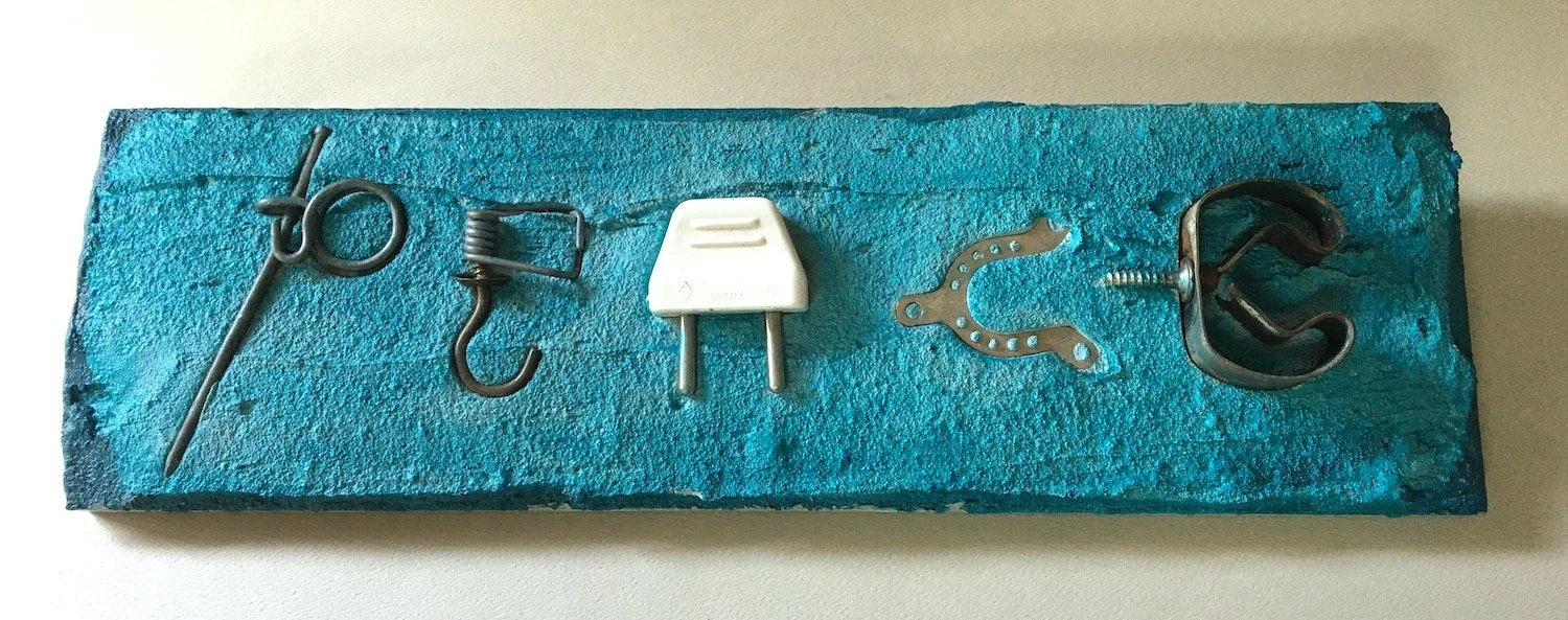 "PEACE" found-object mosaic (13" x 4")