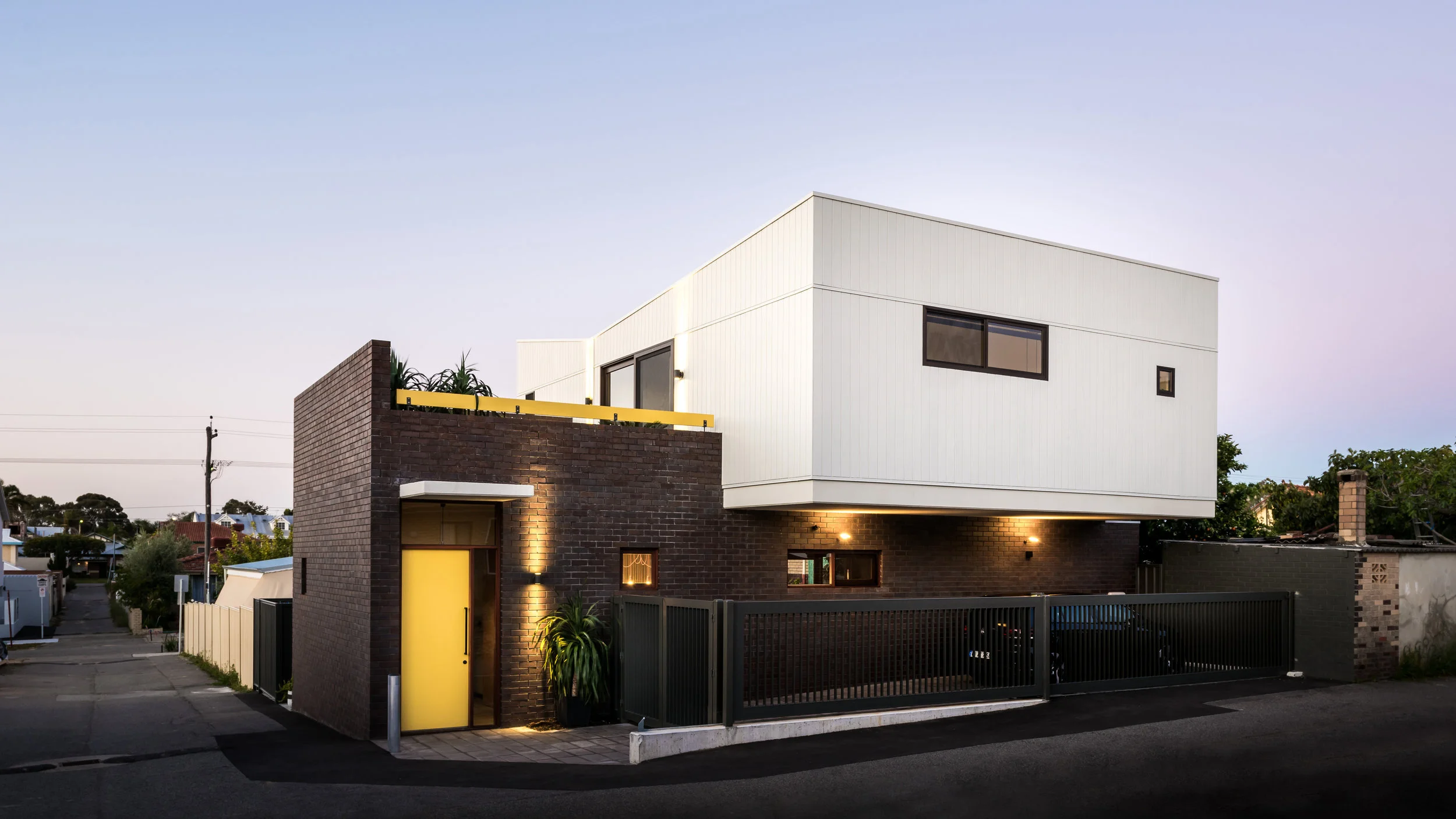 Dolce Ln. This home proves that a generous sized home can be achieved on a small inner-city block for a modest budget. A young couple working on the mines sought an urban home that was robust enough to lock up and leave for their stints on site, but warm and inviting to serve them during their breaks in Perth. The site was small, nestled behind a period home in North Perth on the corner of a rear lane. The design employ solutions to provide the indoor and outdoor spaces to serve the family, while maximising access to North light, the views and the landscaping. A roof deck leads off a second living space upstairs creates additional livings spaces on this small block. The location adjacent the intersection of a lane allows this deck to open to the views and the breezes, while a perforated screen wall provides privacy to the front neighbour.