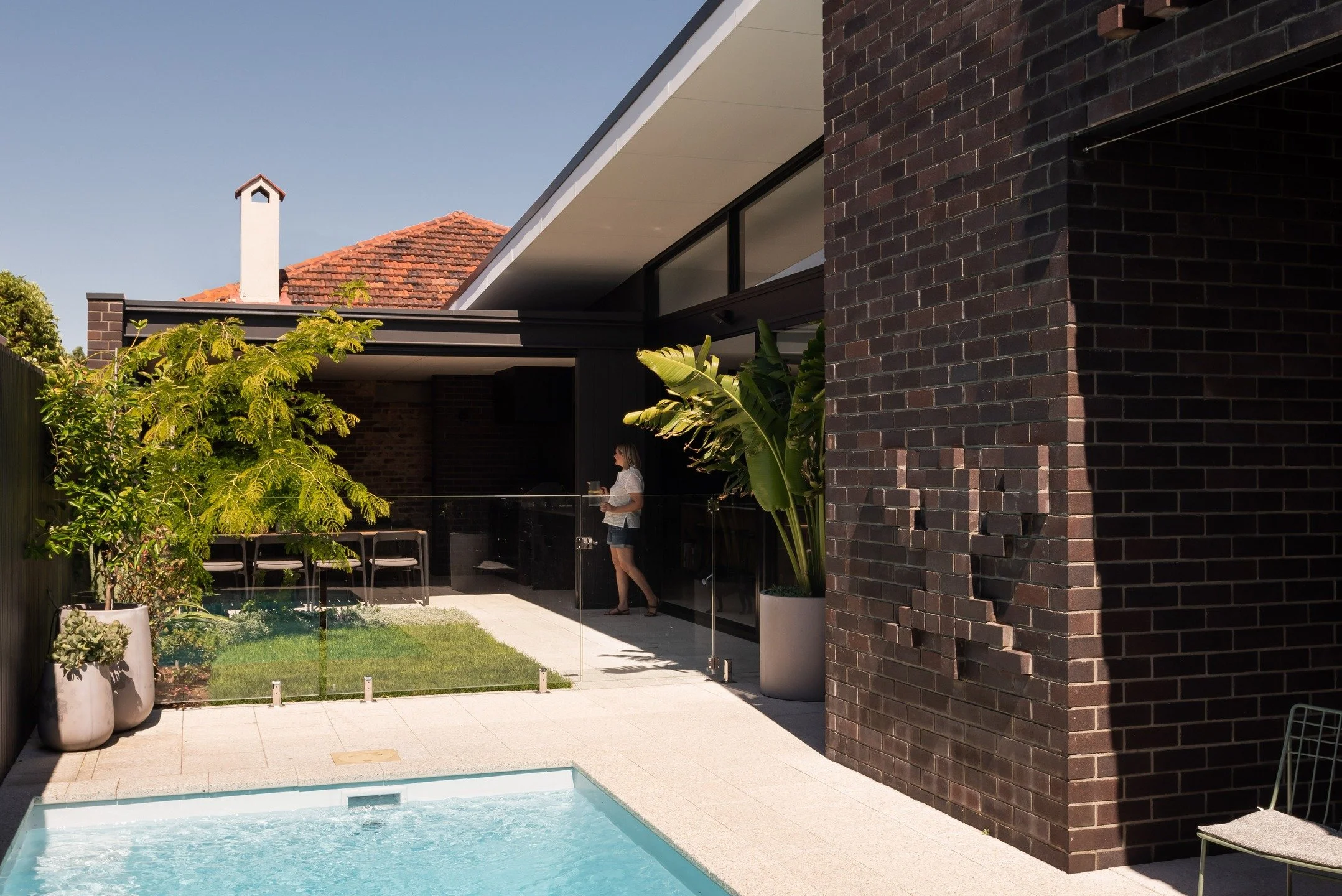 Federation Street Residence.
A mid-century bungalow meets playful nostalgia. Light-filled spaces, warm timber, dark bricks &amp; fun &lsquo;Galaga&rsquo; brick motifs bring character and joy to every corner&mdash;celebrating memories while creating a