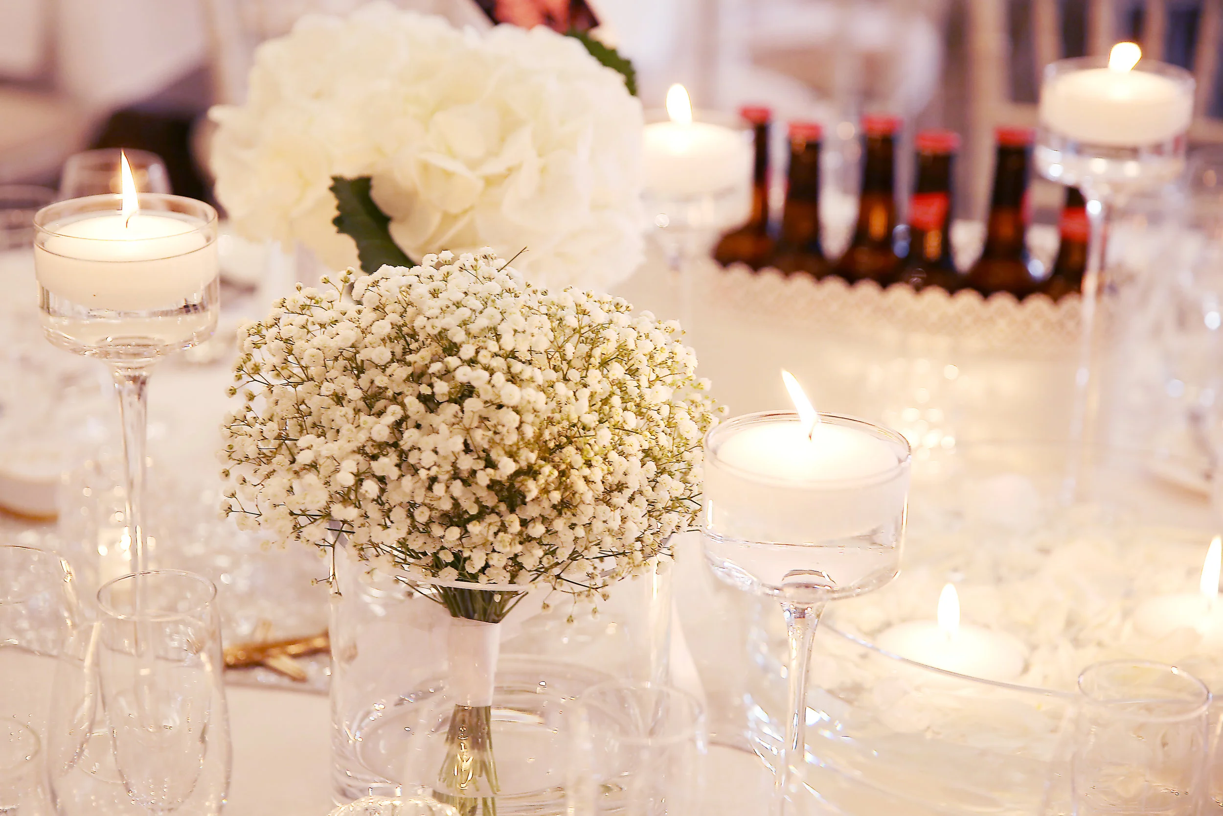 In some cases, where the style and flowers suit, you can use the bouquets on the tables too.