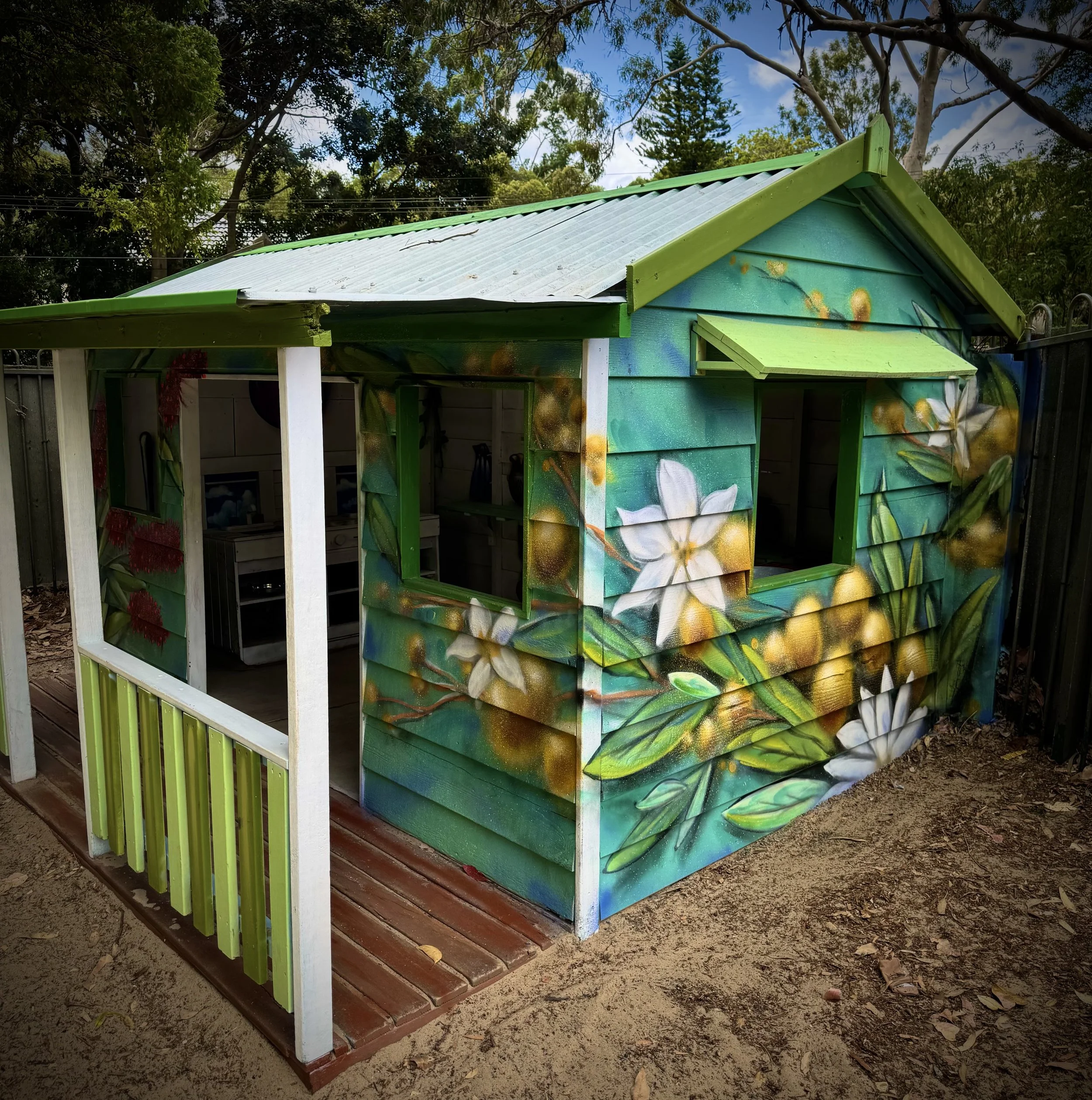 Native wattle Flower Mural painted on the cubby house in the playground of Seaforth Childcare on the Northern Beaches
