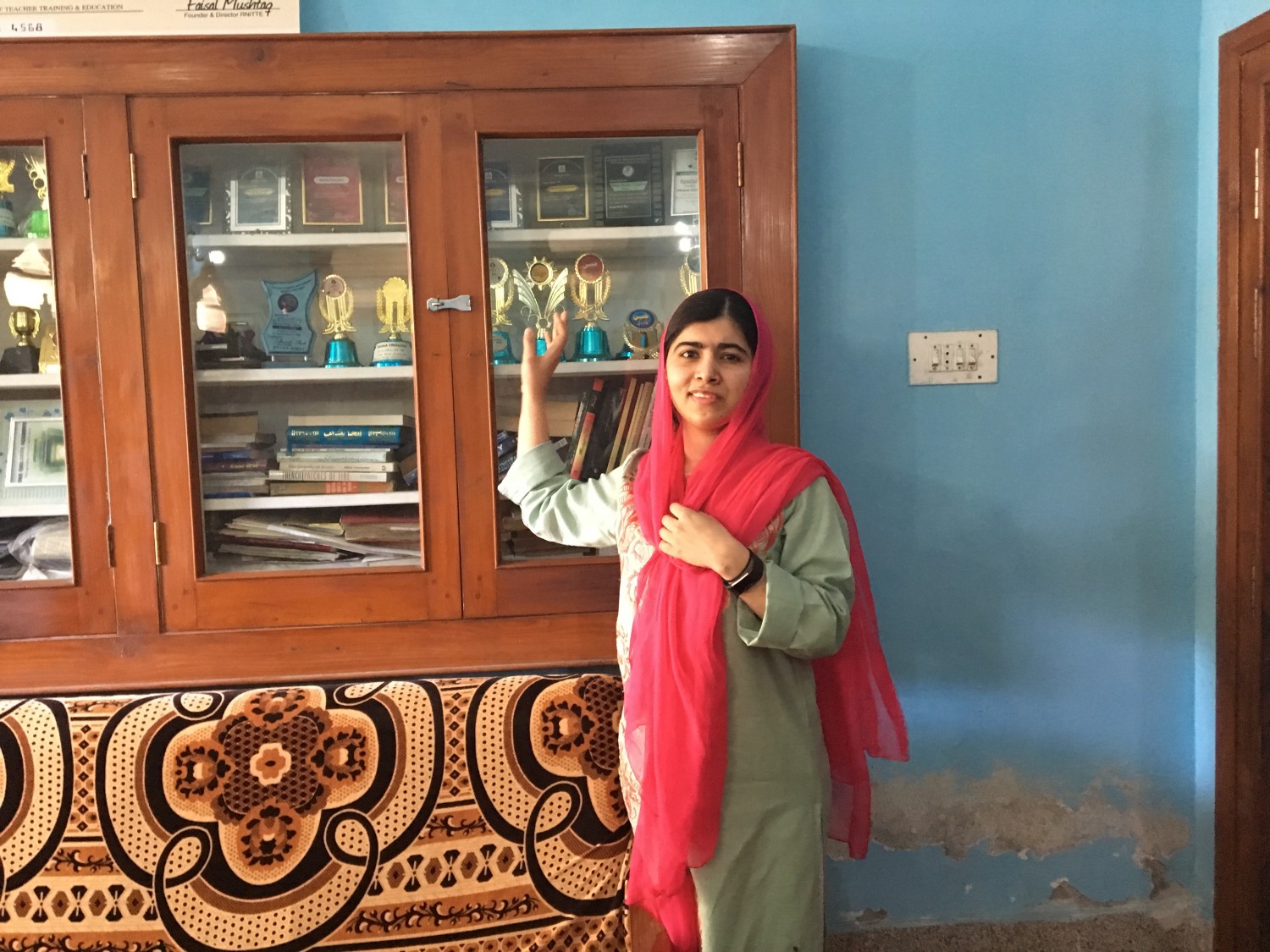 Malala with her trophies from school. (Courtesy of Insiya Syed / Malala Fund)