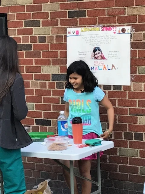 Anya holds a lemonade stand on Malala’s 21st birthday. (Courtesy of Anya Sen)