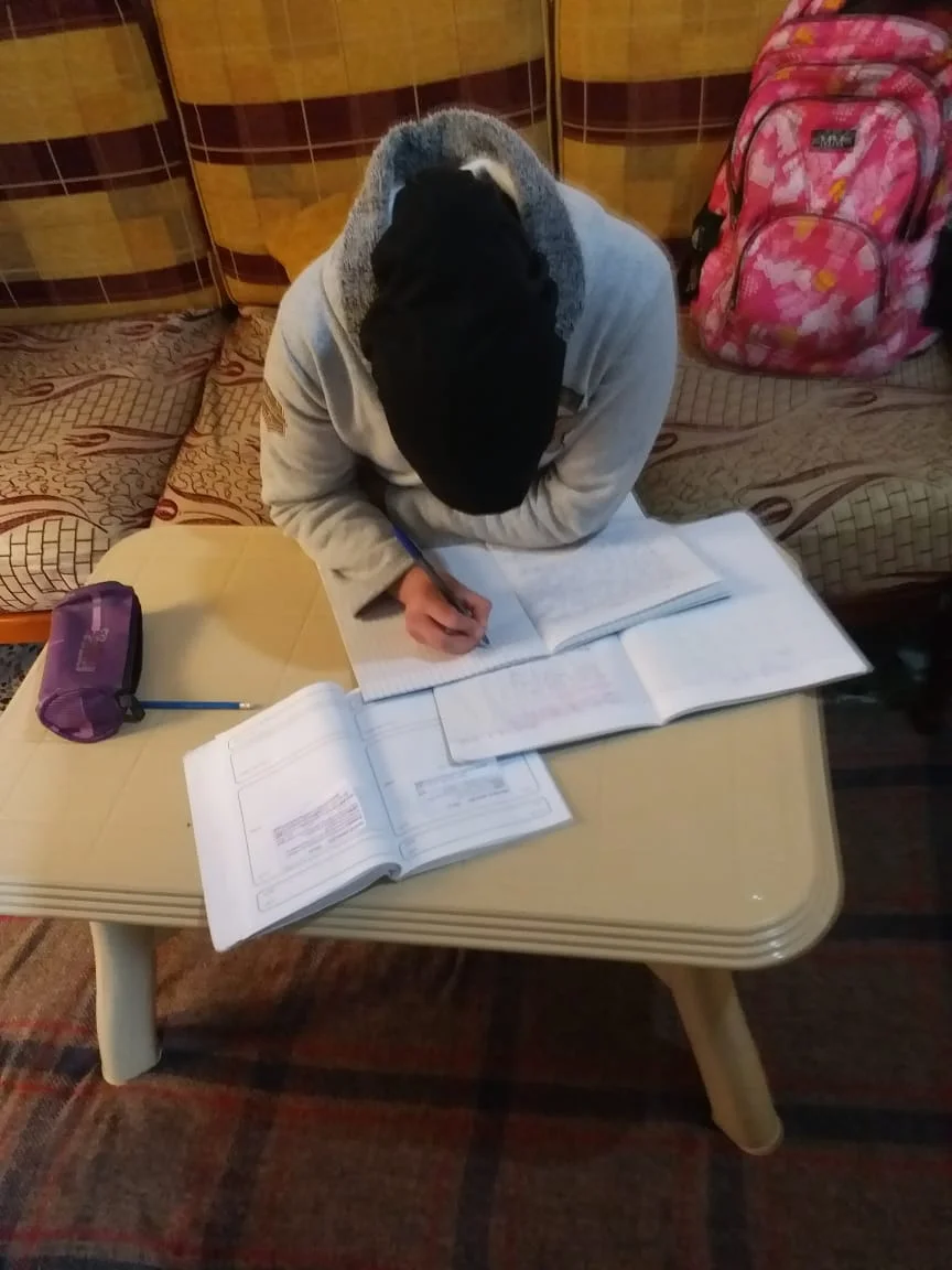 In my house doing homework. (Courtesy of Reem)