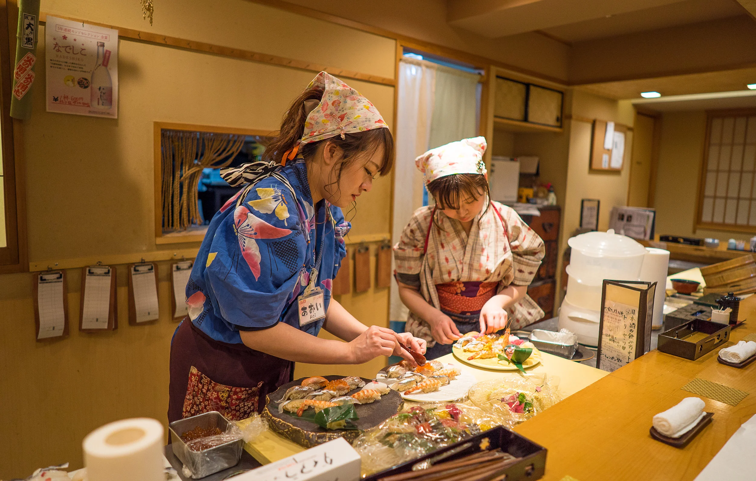 Yuki and a fellow sushi chef plate dishes to serve at Nadeshiko Sushi. (Courtesy of Amarachi Nwosu / Malala Fund)