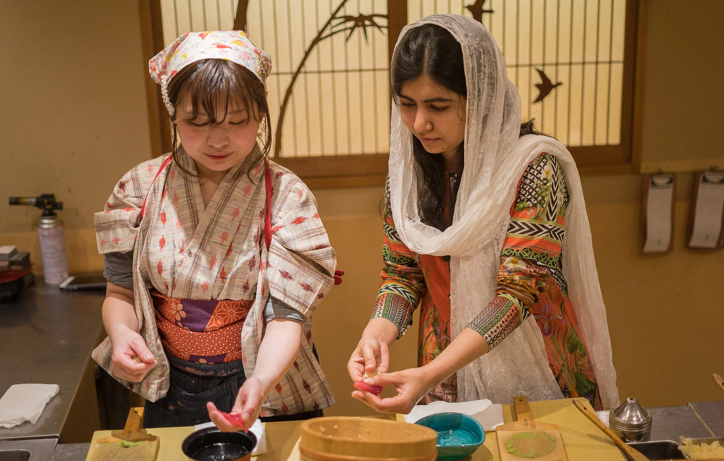 On her trip to Tokyo, Malala Yousafzai visited Yuki Chizui at her restaurant, Nadeshiko Sushi, to hear about her work to advance women in the industry. After sampling some dishes, Yuki taught Malala how to make sushi in the Japanese tradition. (Courtesy of Amarachi Nwosu / Malala Fund)