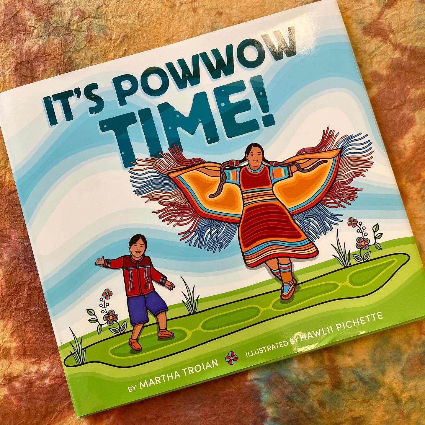 Bineshii is looking forward to his first powwow. He wakes up and travels with his family to the community event. He eats bannock and drinks strawberry juice as he watches the dancers perform. And ever so slowly, Bineshii works his way from the edge o