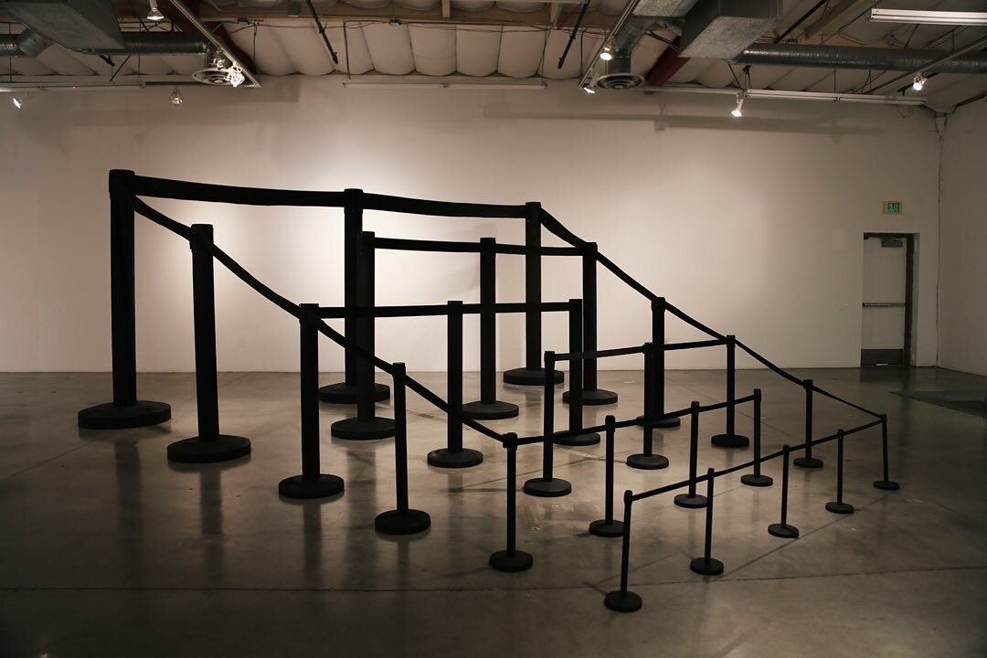 &quot;The Waiting Line&quot; by Reed van Brunschot @reedvanbrunschot
A set of amplified wait lines or stanchions are set up reminiscent of the kind you would find in a bank or TSA/Customs line. Stanchions are normally designed to move or handle large