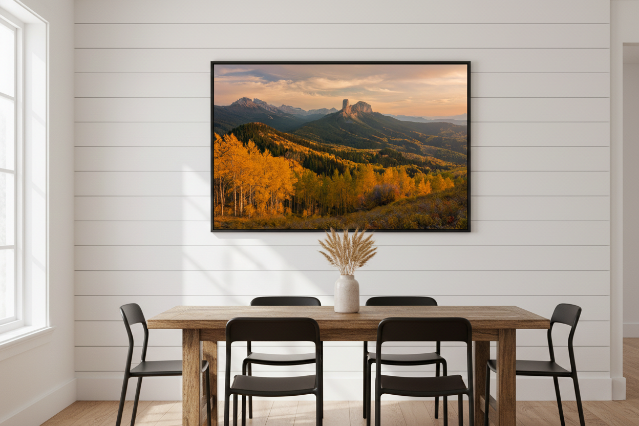 Horizontal black-framed landscape photograph of Chimney Rock in autumn hanging on a white shiplap wall in a modern farmhouse dining room.