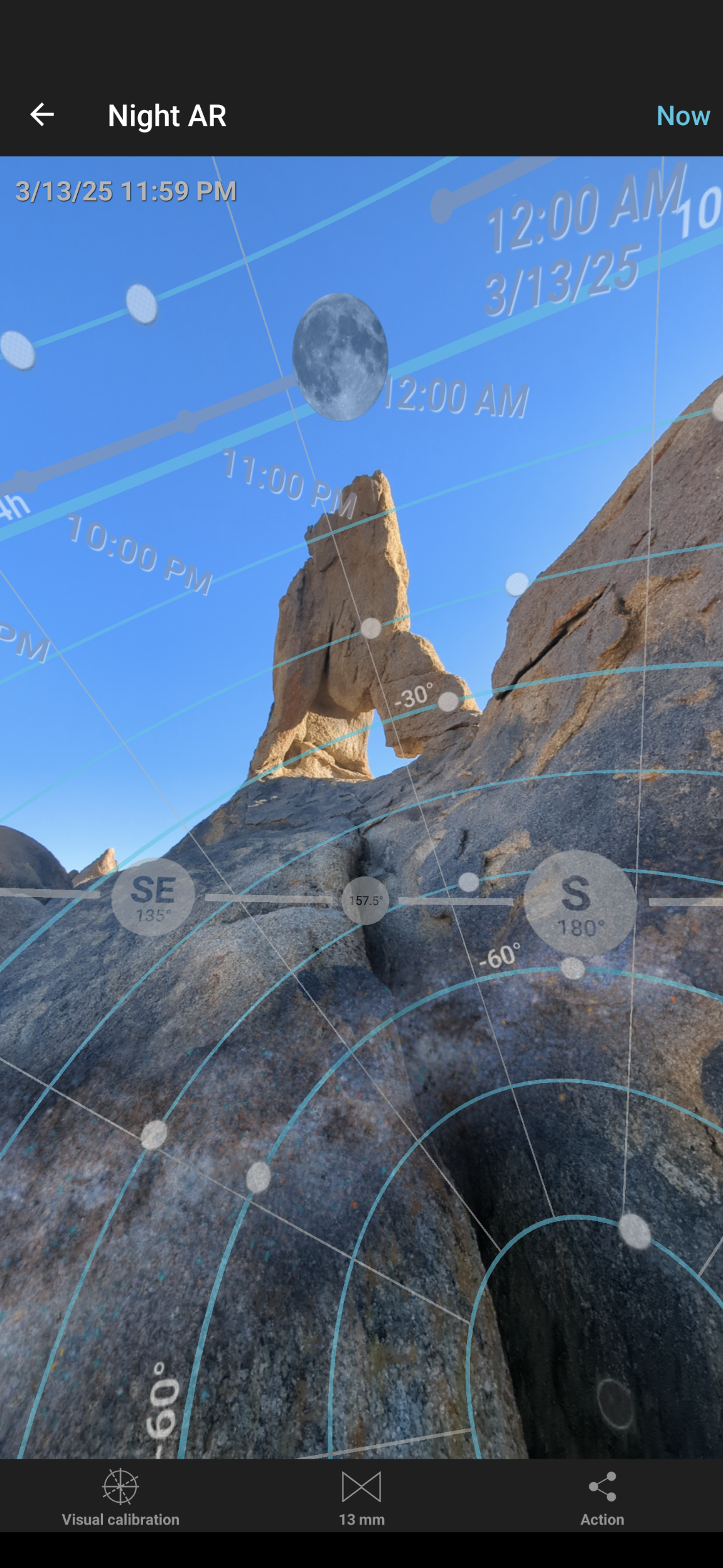 Vertical smartphone screenshot of PhotoPills Night AR mode showing a 3D overlay aligning the moon over a desert rock arch during daylight scouting.