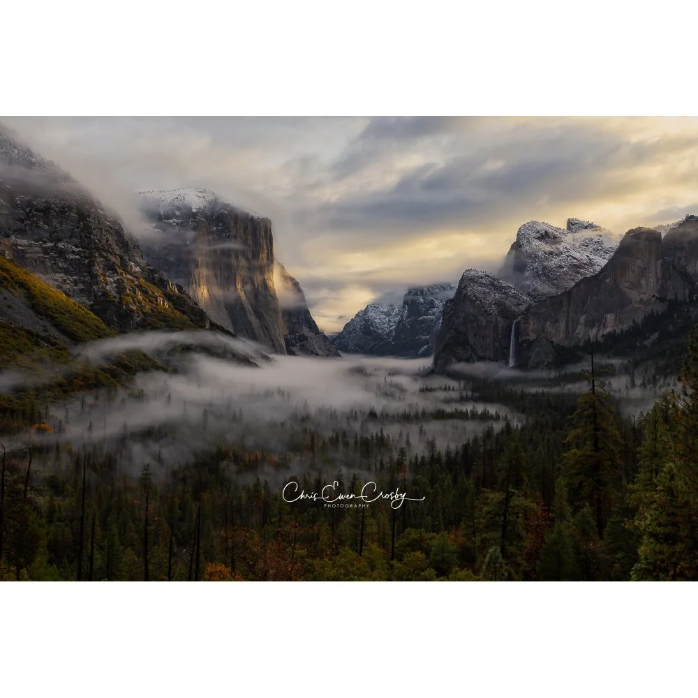 Wide-angle landscape photo of Yosemite Valley at sunrise with low fog, El Capitan, and Half Dome.
