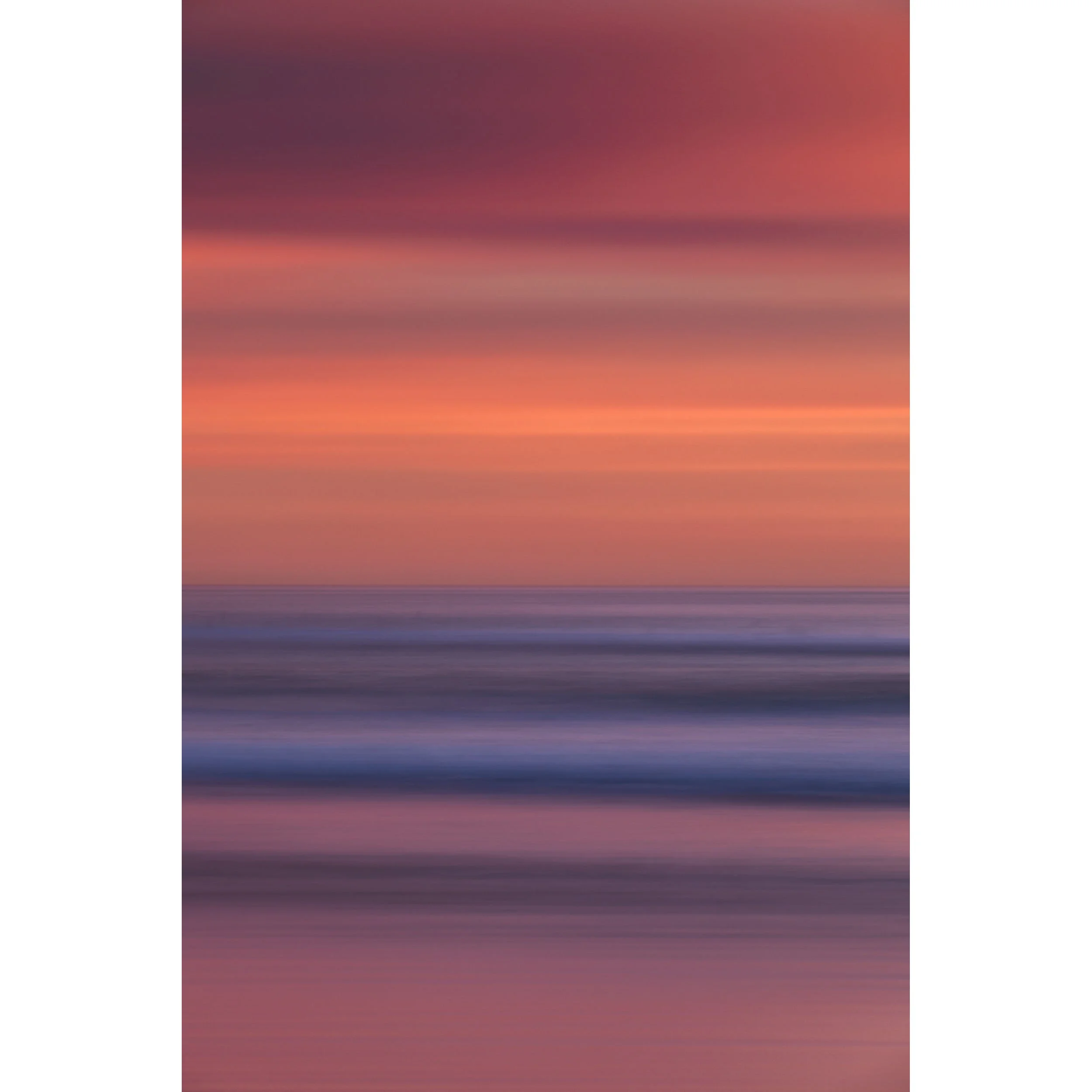 Vertical abstract photograph of a beach sunset created with camera movement, showing smooth horizontal bands of coral sky and soft purple ocean waves.