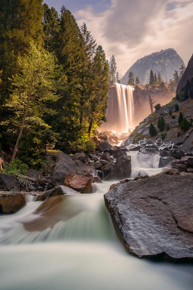 Long exposure of Vernal Falls in Yosemite, showing silky white water flowing over dark rocks.