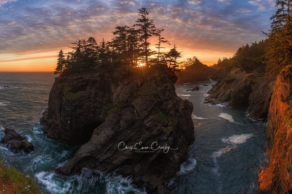 Horizontal seascape of Natural Bridges in Oregon at sunset, featuring stone arches, misty ocean spray, and golden sky light.