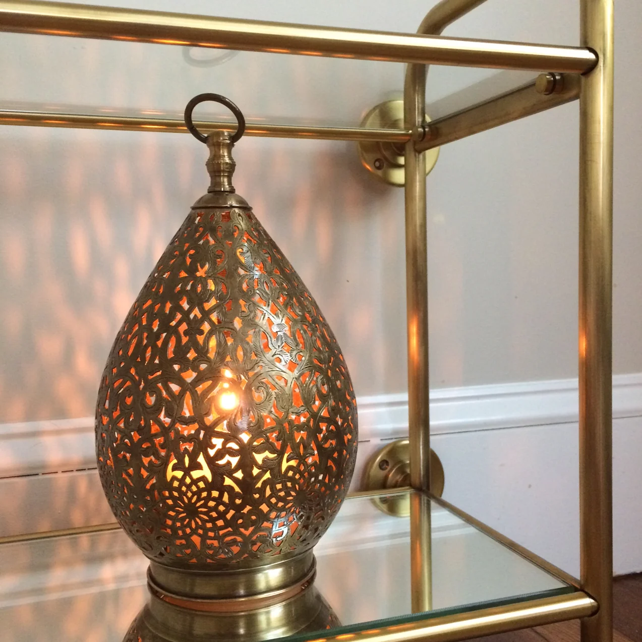 Accessories in progress: Moroccan brass lantern—from Morocco—on Pottery Barn's vintage wall shelf