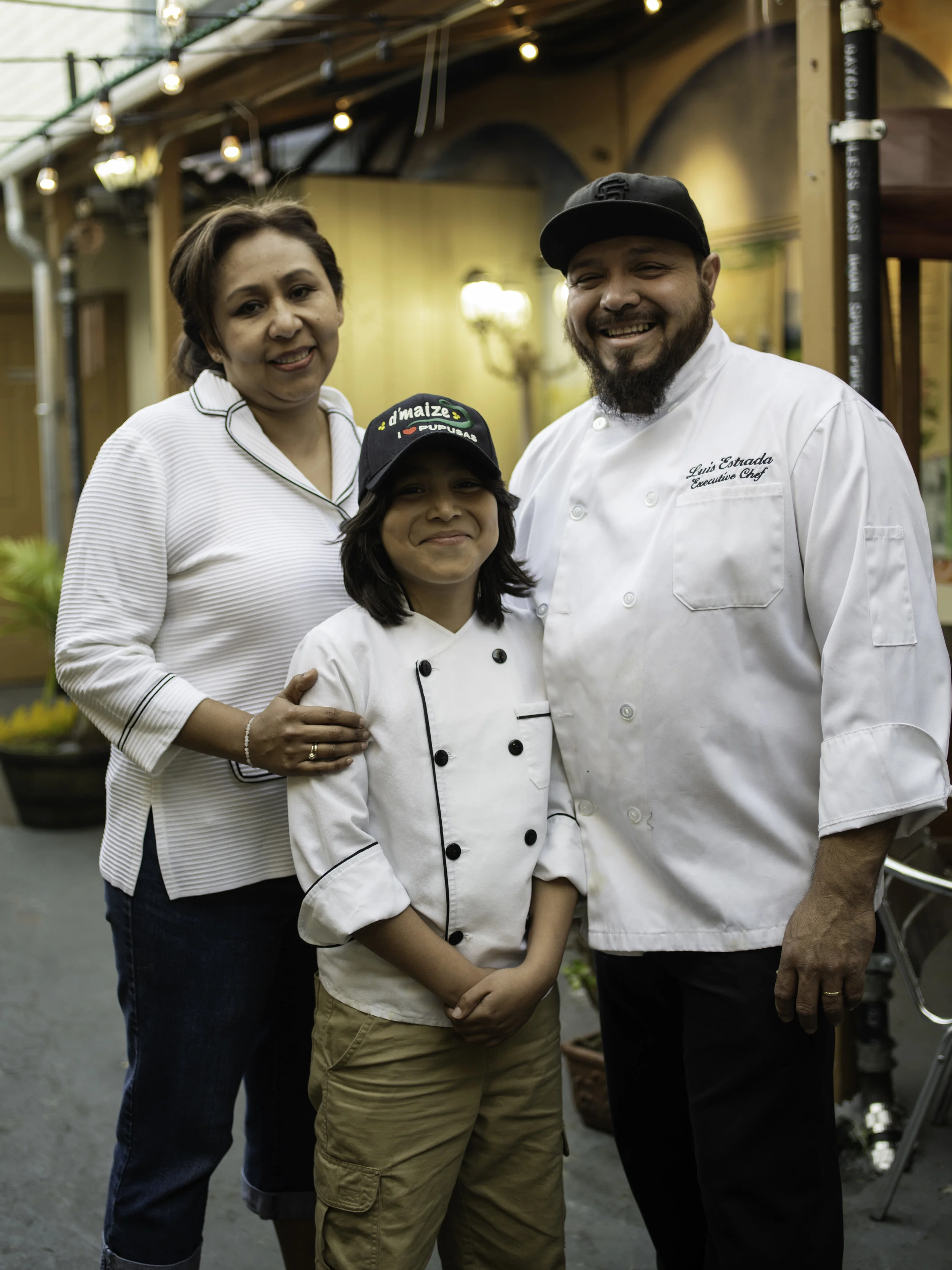 Zenaida Merlin, Luis Estrada, and their son Mateo at their restaurant D’Maize. Image courtesy DoorDash .