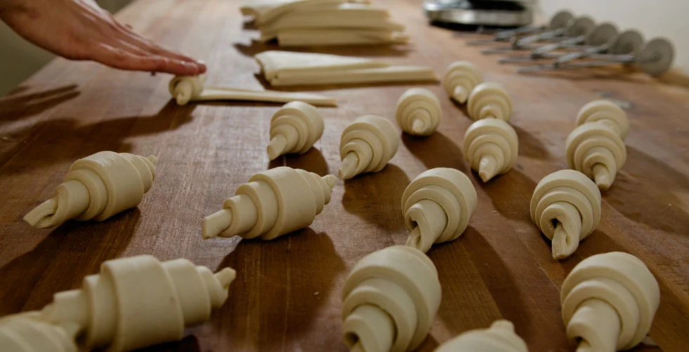 Rolling out croissants. Image courtesy of Frank Wing Photography .