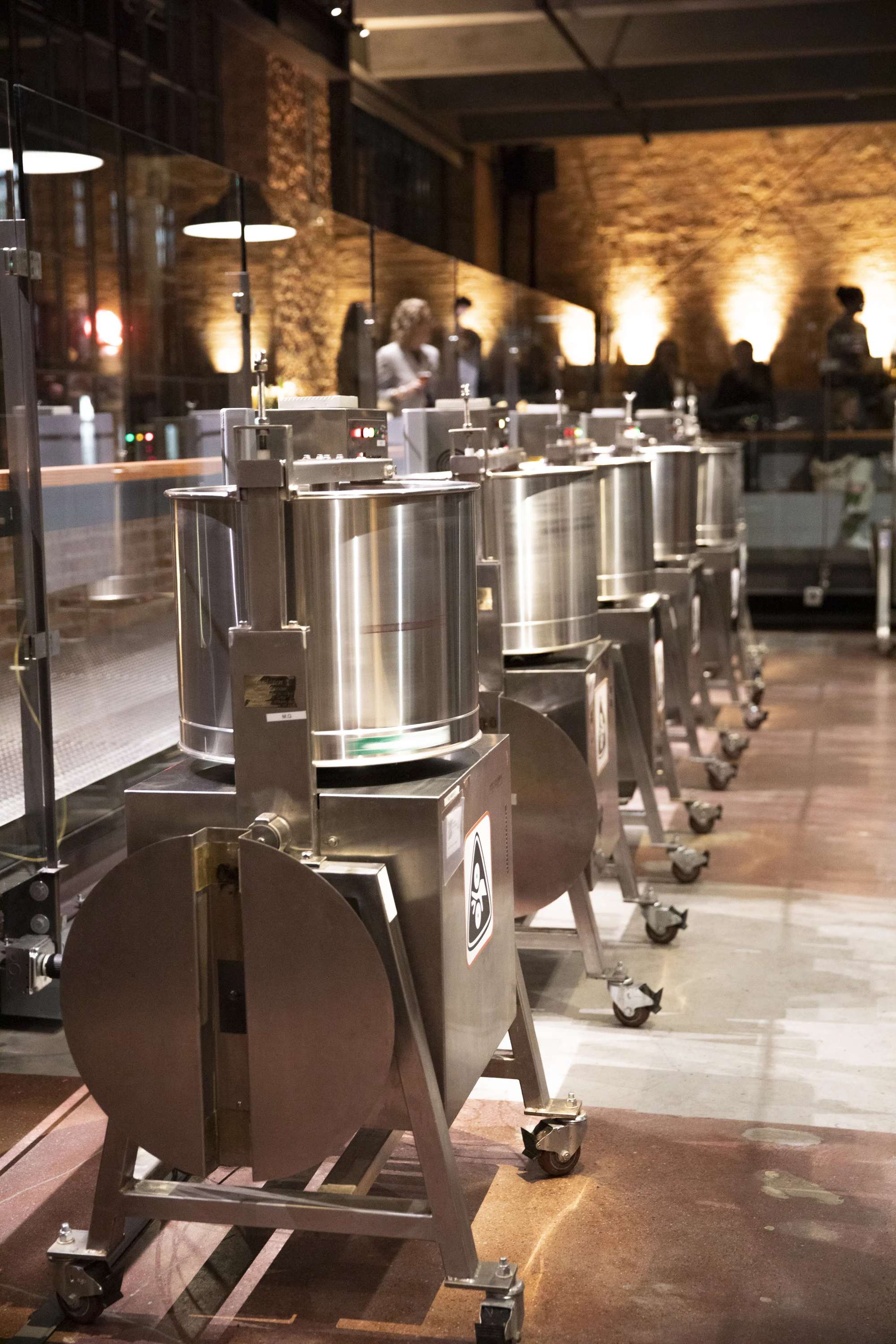 On display: A row of machines designed to grind down cacao nibs and sugar so that the ingredients fully integrate and form a silky, chocolate liquid. Photo: Anne Fishbein