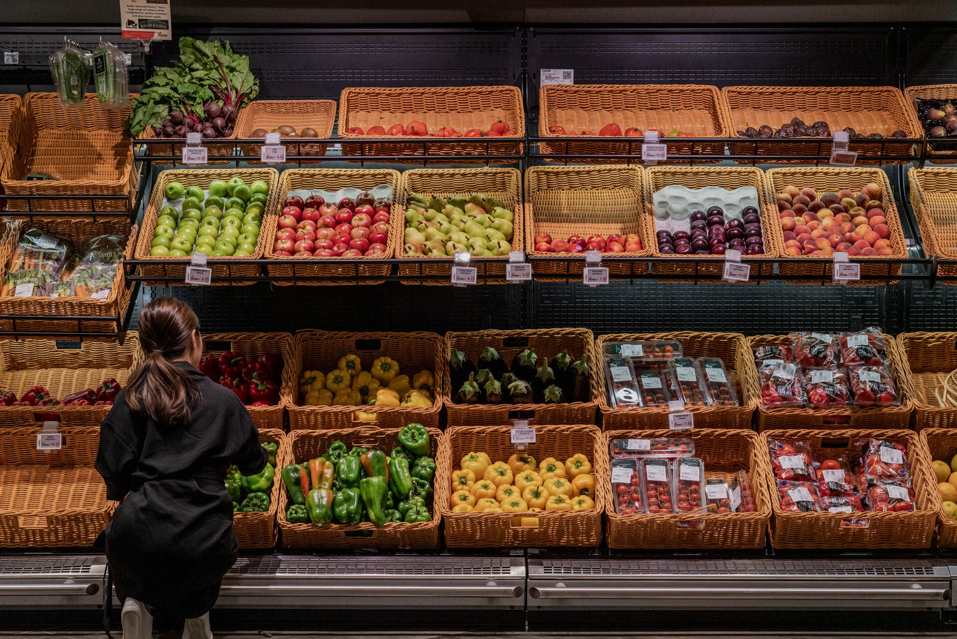 baskets containing fruits and vegetables arranged side by side in several rows