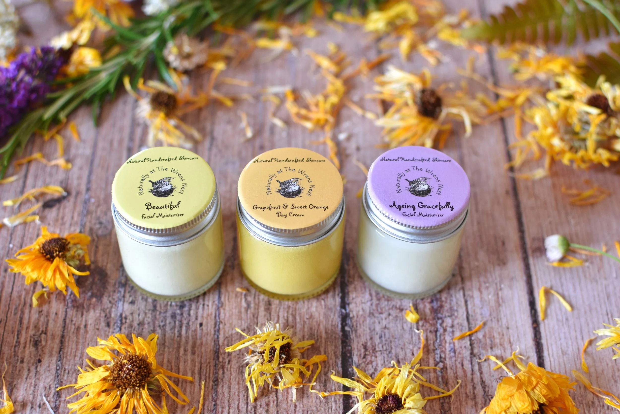The 3 different facial moisturisers from naturally at The Wrens Nest, on a backdrop of dried flowers