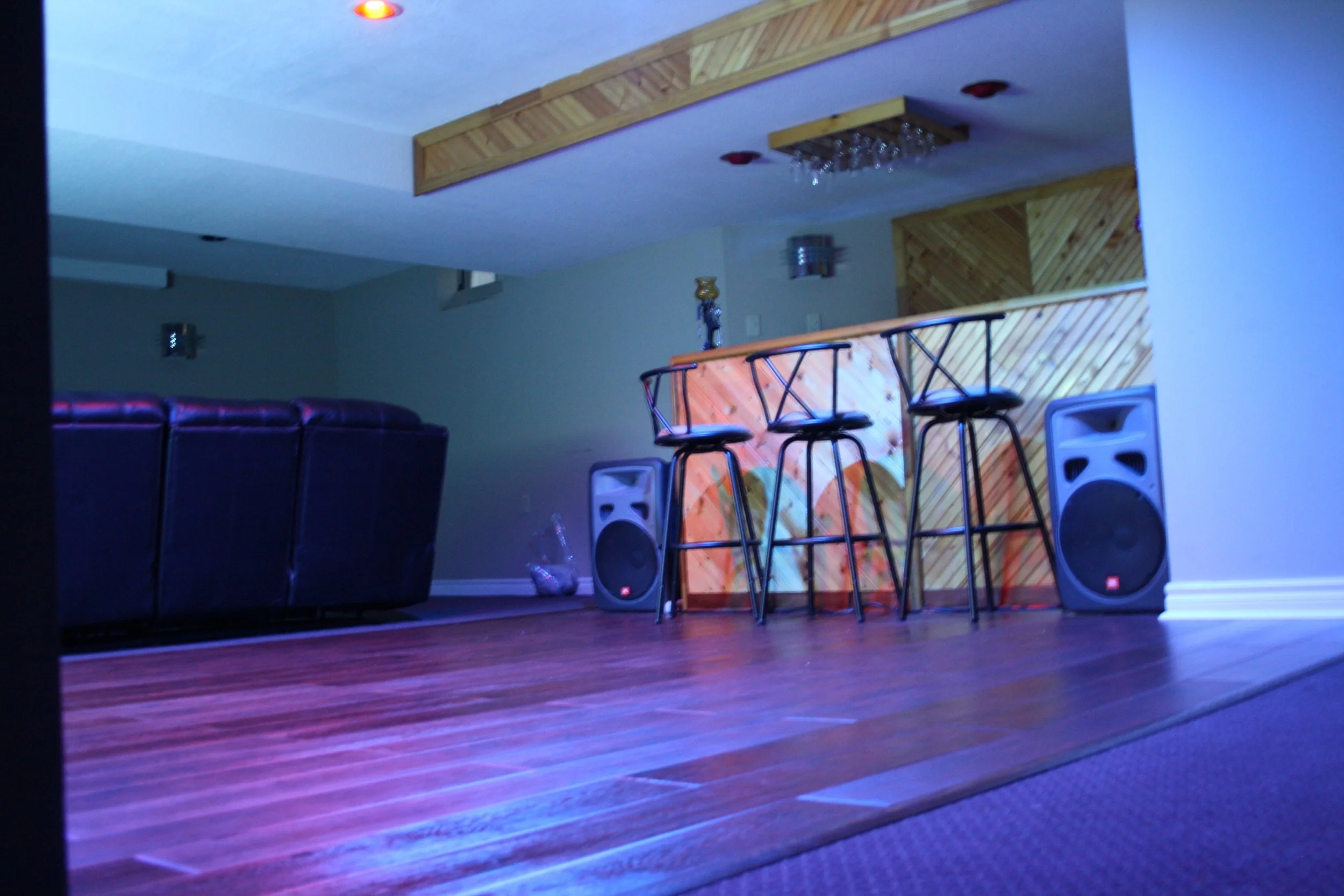 Floating dancefloor in middle of carpeted basement
