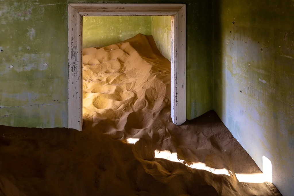 An abandoned house being reclaimed by the desert