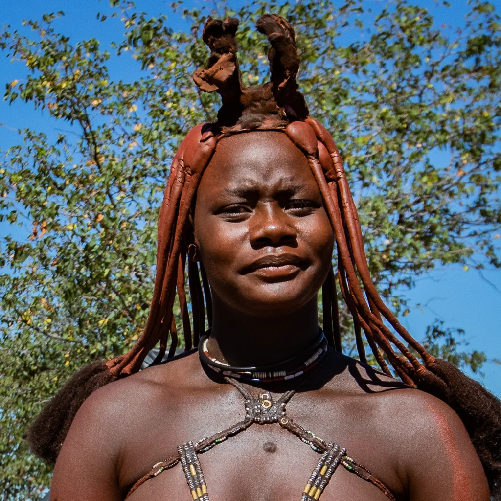 A Himba lady sporting her traditional head gear