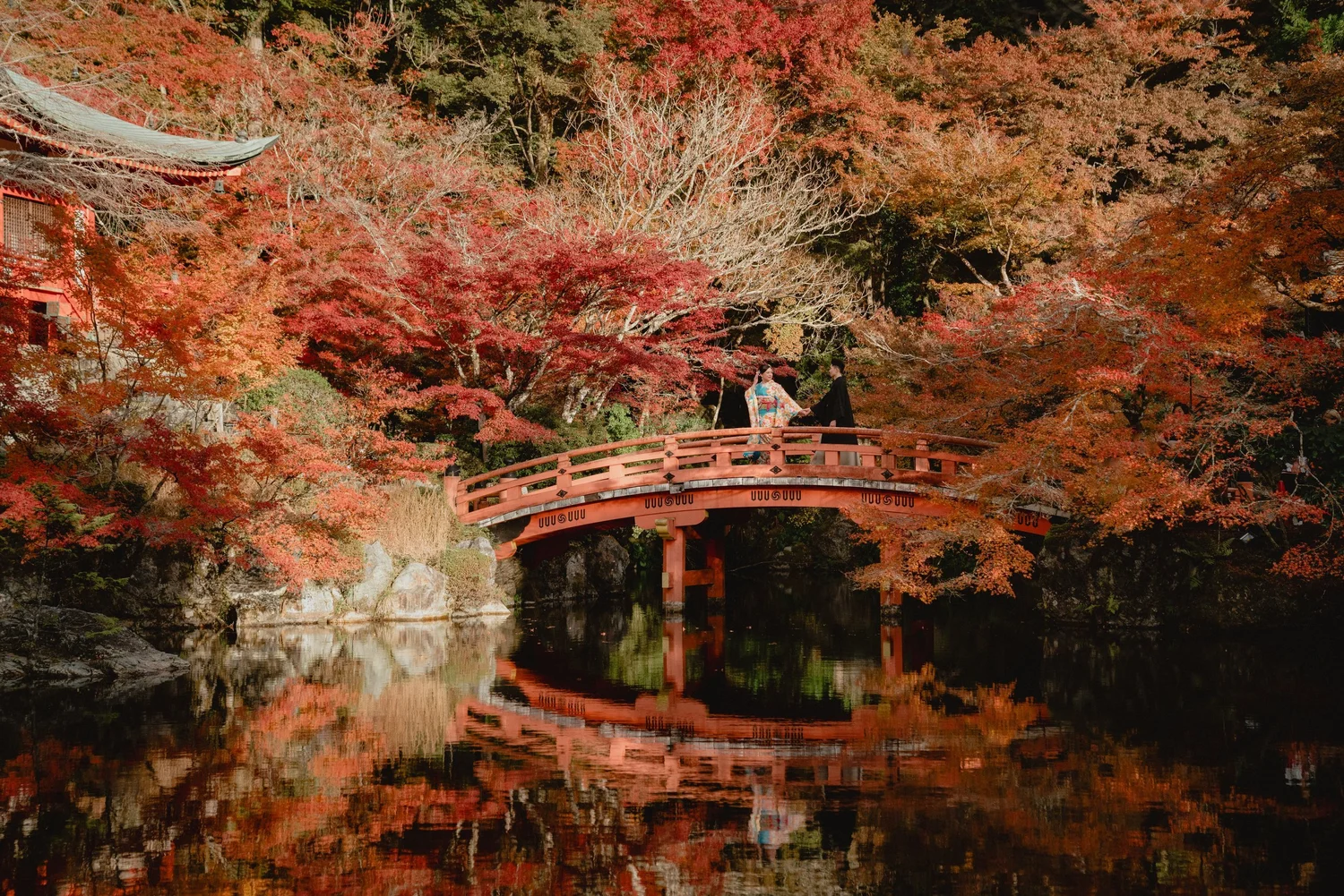 A couple celebrating together on a red bridge