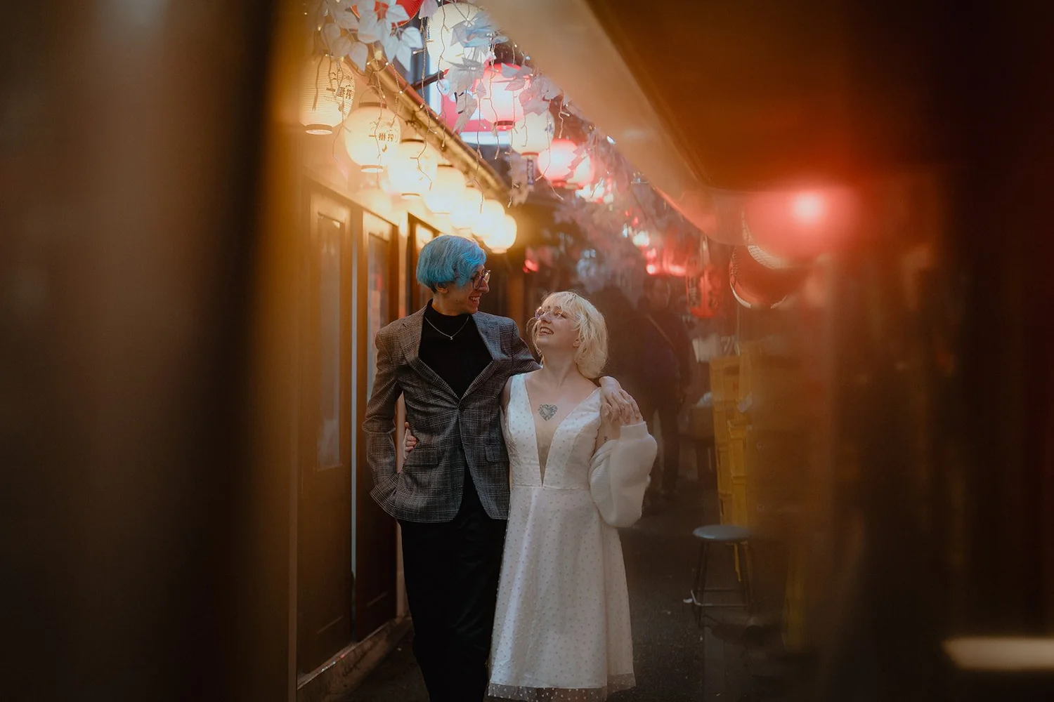 A couple walking together in a warm Tokyo alley