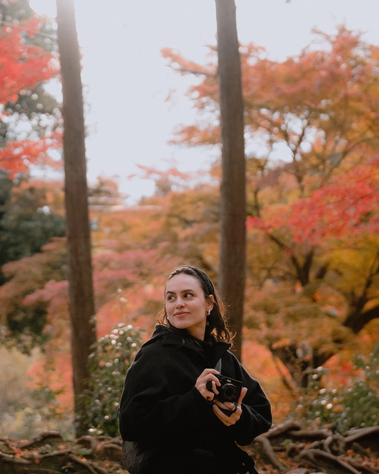 Bruna Luise holding her camera in Japan