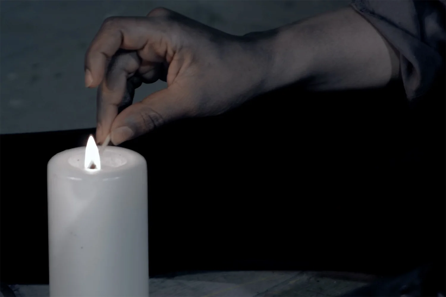 phoebe_nightingale_stay_the_burning_short_film_experimental_ronke_adekoluejo_lighting_candle.jpg