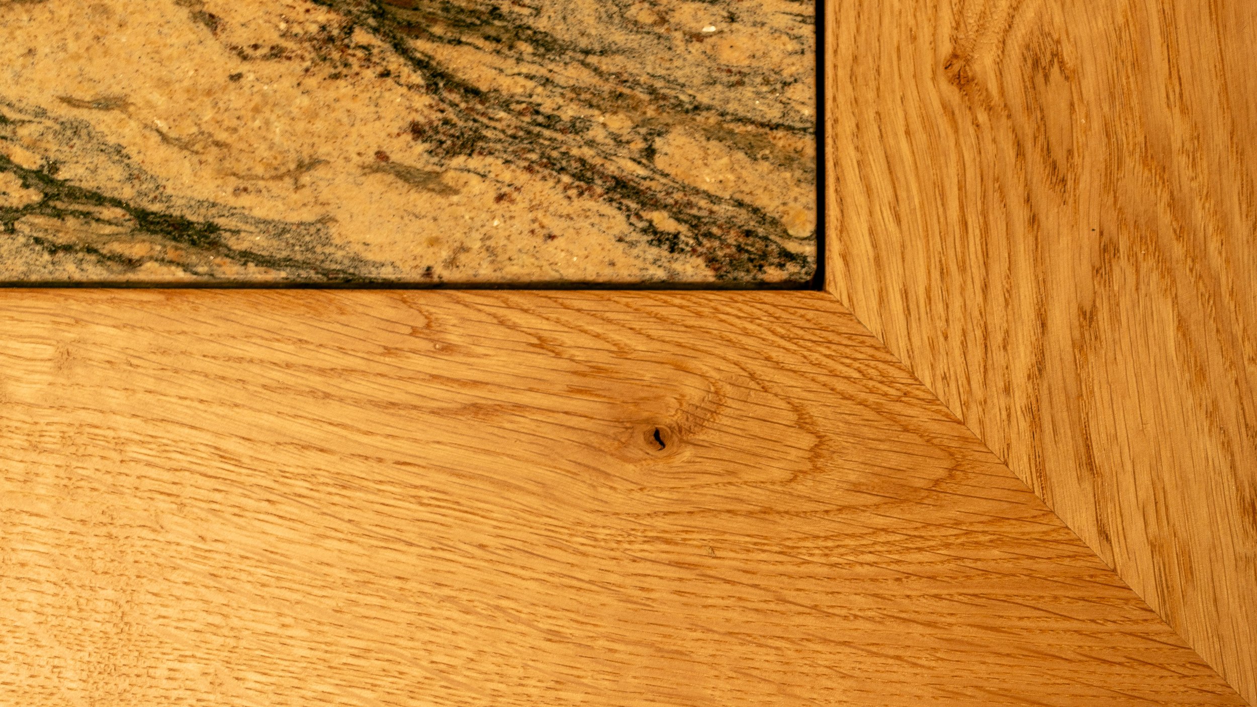 Close up detail of oak mitre and granite dining table