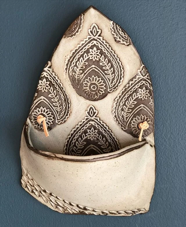 ☃️This handmade  wall pocket Just awaiting a succulent, plant or anything of your choice , showcasing our logo in a nice matte finish ✨ 
swipe to see the video last week of  high fire glazing process/relief process.. ( before/after)Frost blue on dark