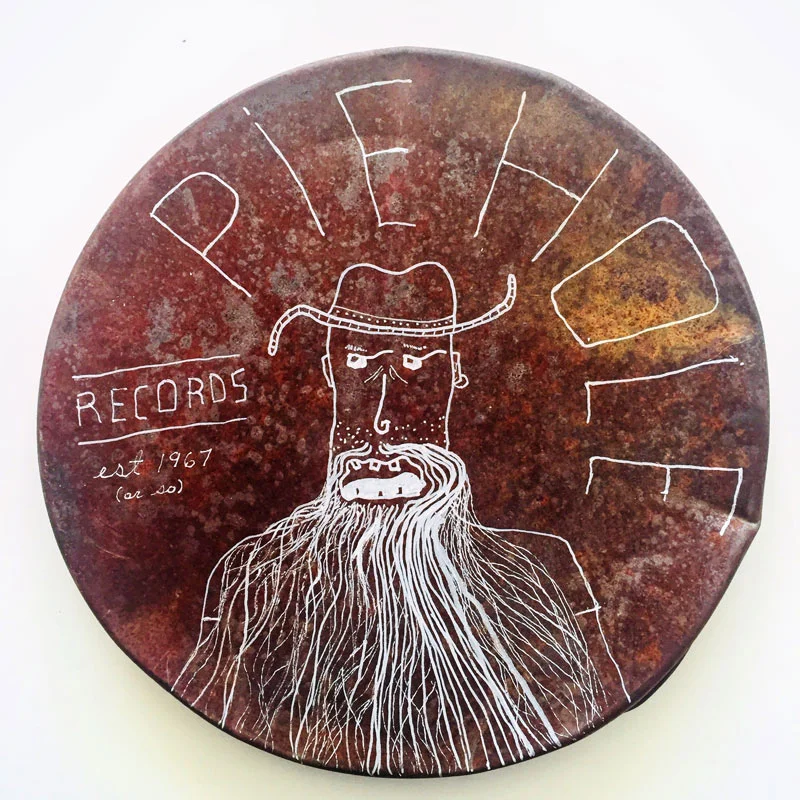 ‘Pie Hole Records.’ Pen and ink on found rusted metal.