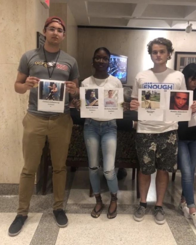 Robert joined Team ENOUGH members Aalayah Eastmond and Sam Sharf in visiting the Florida State Capitol to protest SB 7030 on arming teachers. He holds a photo of his sister, Carmen, who was killed in the Parkland shooting.