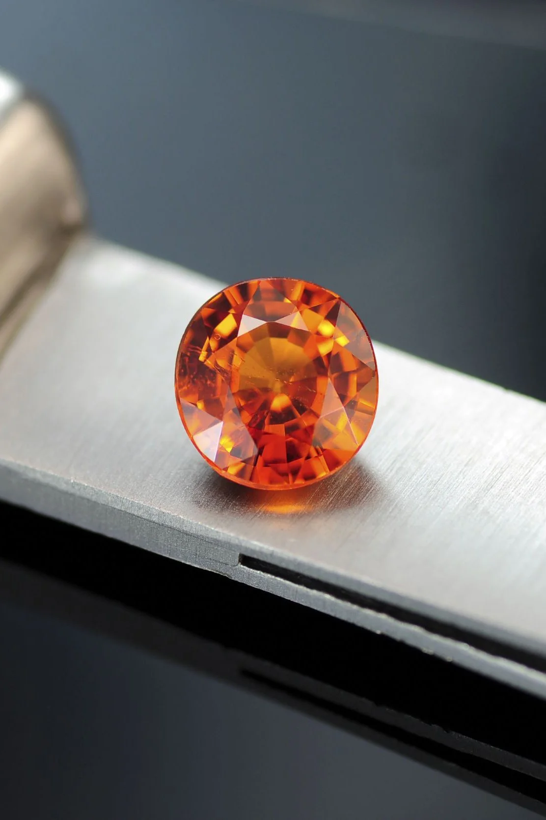 orange garnet resting on a knife
