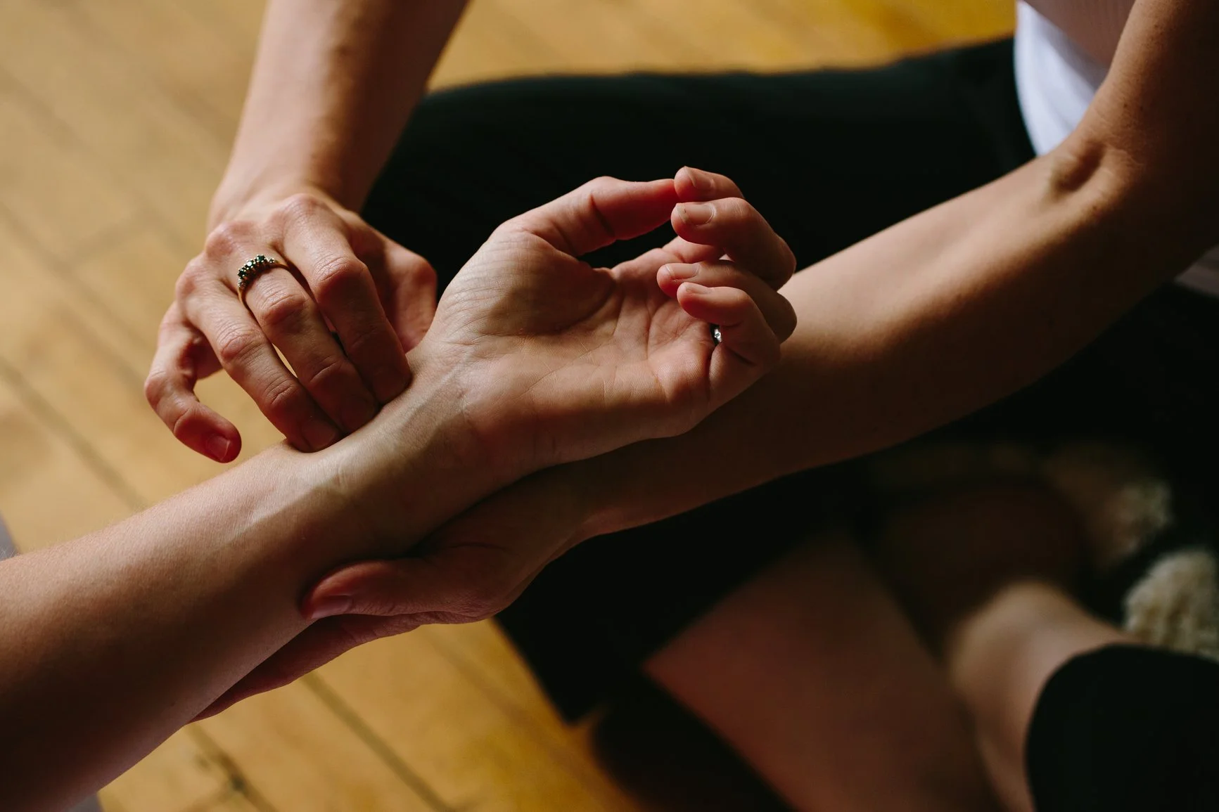 Ayurvedic practitioner performing a traditional pulse assessment during a health consultation at Setu Vermont.