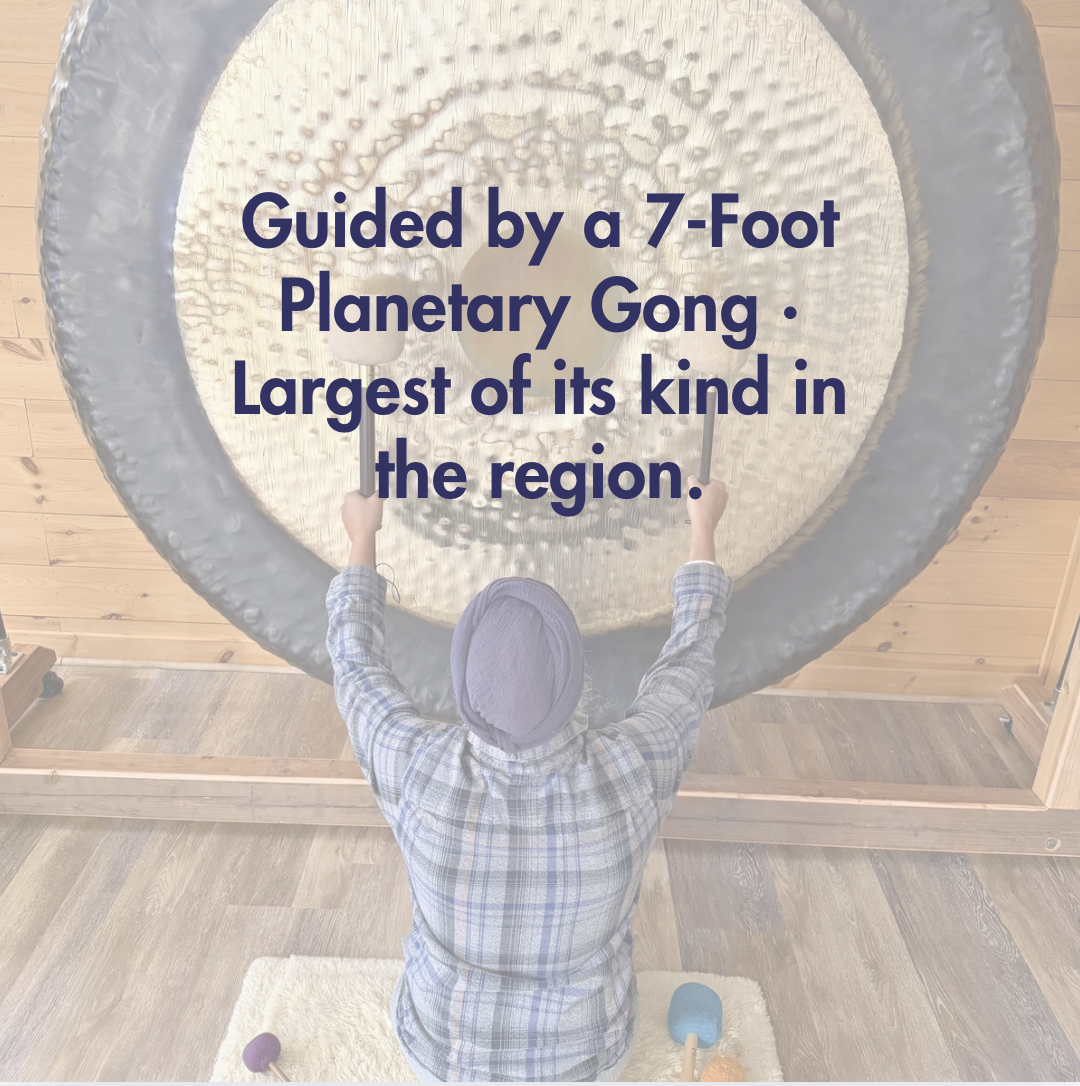 Harmeet Singh leading a gong meditation in front of a 7-foot planetary gong at Setu Vermont retreat center