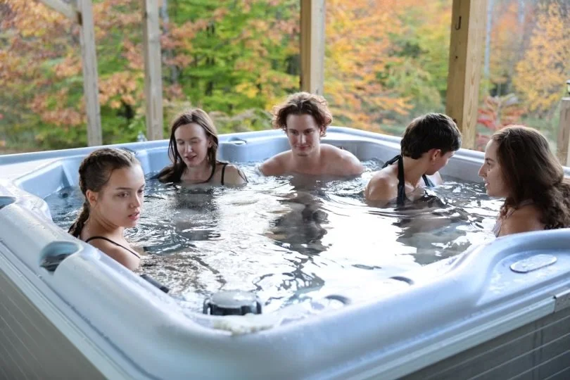 Retreat guests relaxing together in an outdoor hot tub.