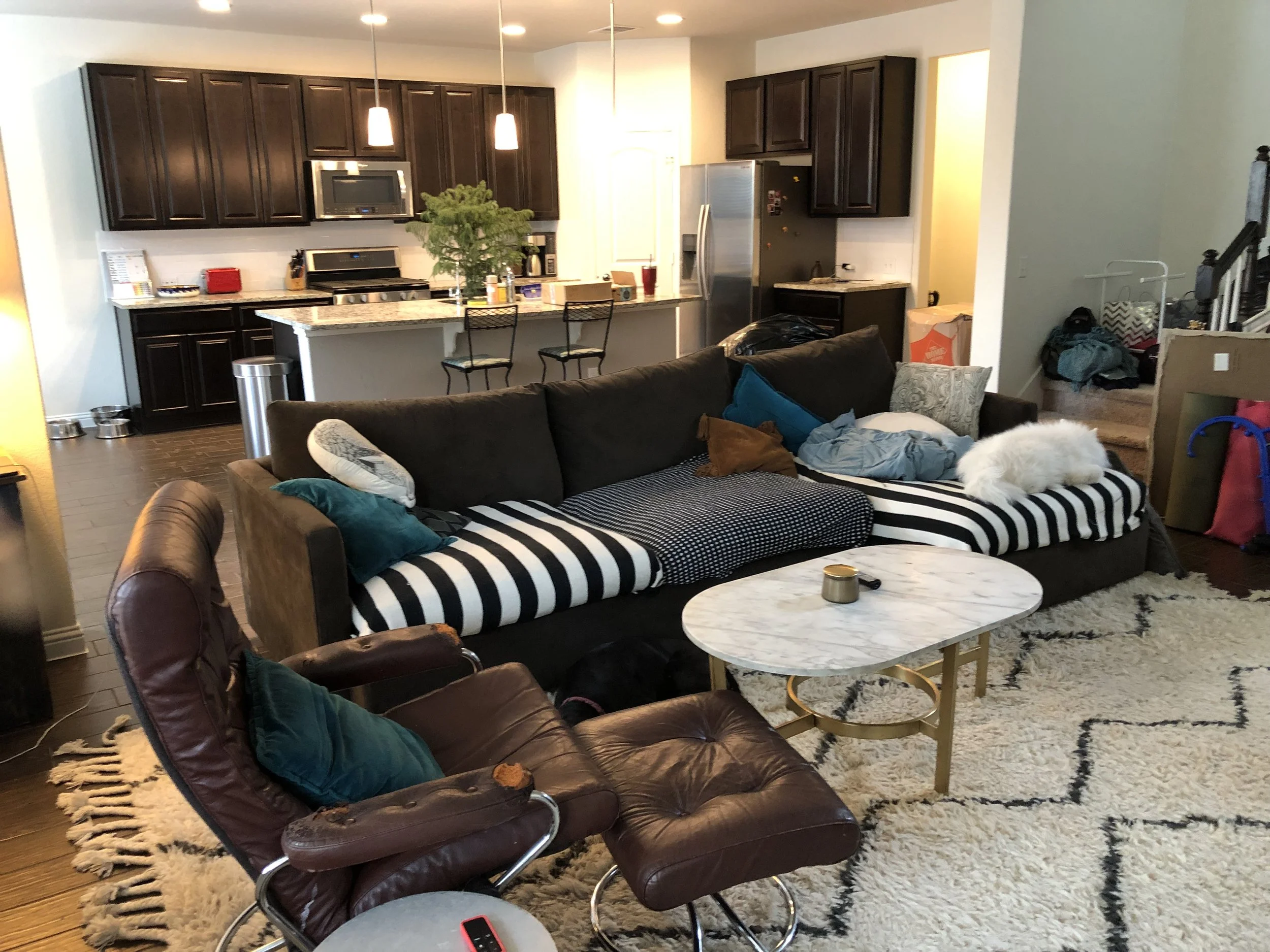 Here’s a before picture of the living room, looking into the kitchen. You can still see some of the crap we haven’t unpacked yet!