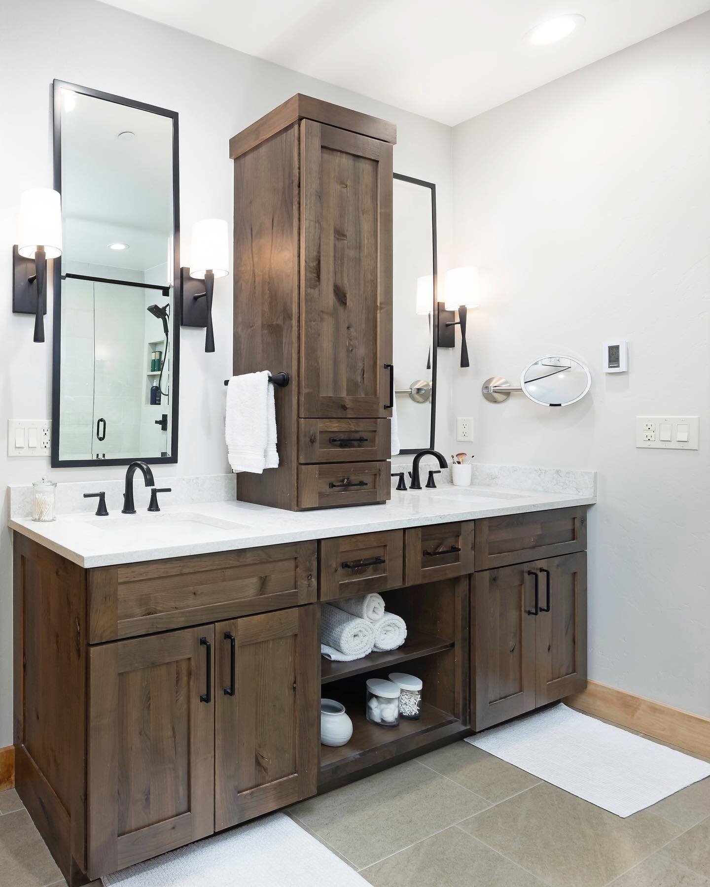 Symmetry is key when designing a client&rsquo;s dream bathroom. We decided to have custom cabinetry installed to utilize the full wall space. Adding the center cabinet between two sinks gave our clients ample amount of usable storage keeping their co