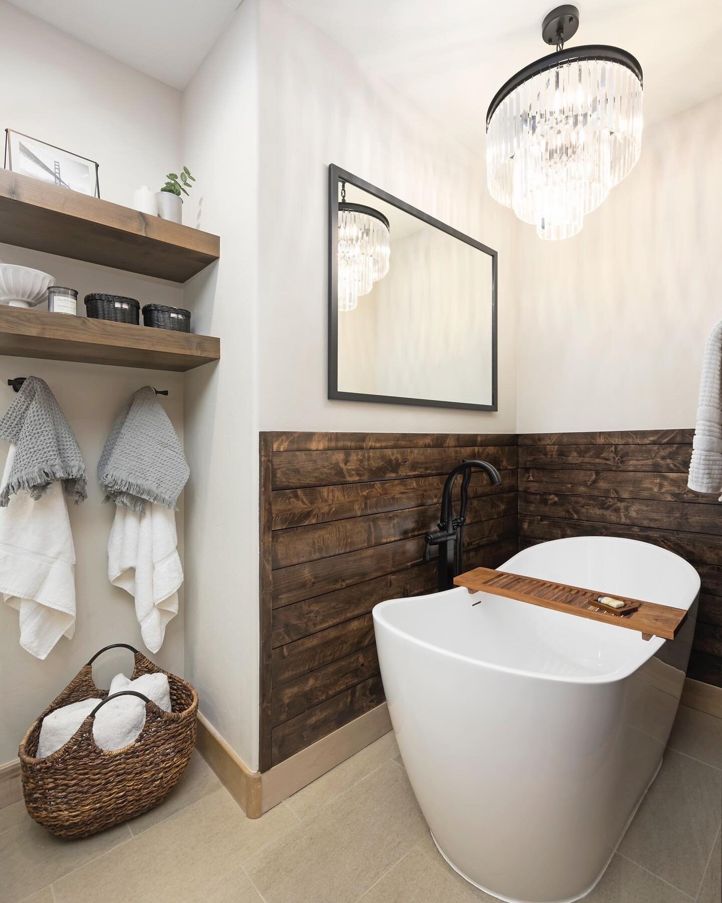 We are taking bath time to the next level. In an area that was originally the shower, we created a separate space in our client&rsquo;s primary bathroom for rest and relaxation. Surrounding the tub with wood and choosing open shelving adds to the spa