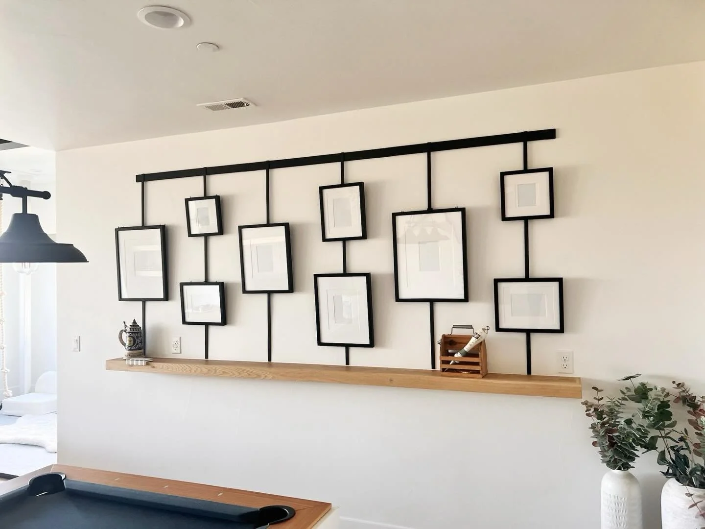 Transforming walls into works of art! My client wanted a unique way to hang her artwork and showcase photos, so we found this amazing rail system. It added incredible dimension and turned the wall into a stunning feature wall. Love how it brings pers