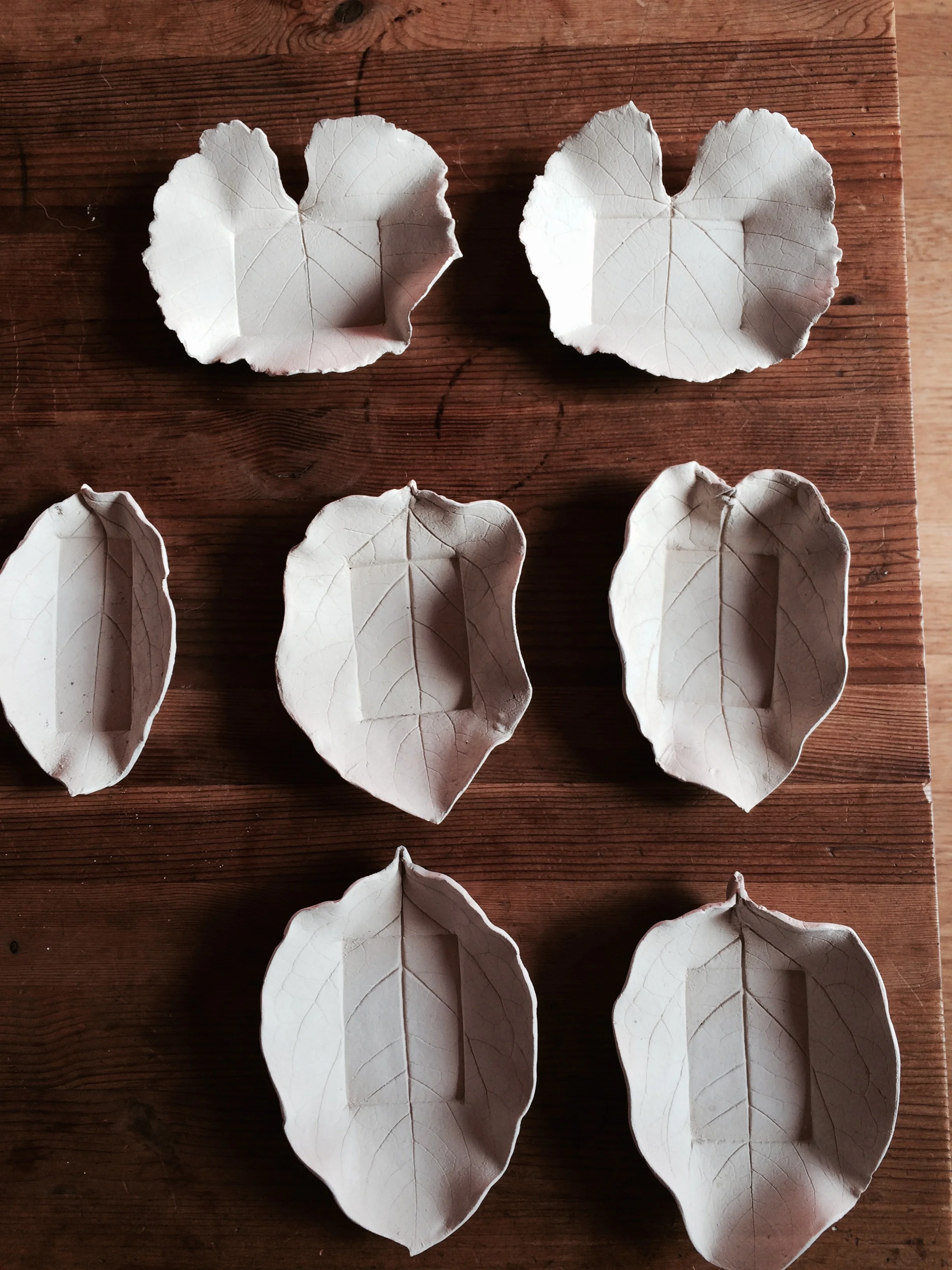Unglazed ceramic plates made from the impression grape and persimmon leaves