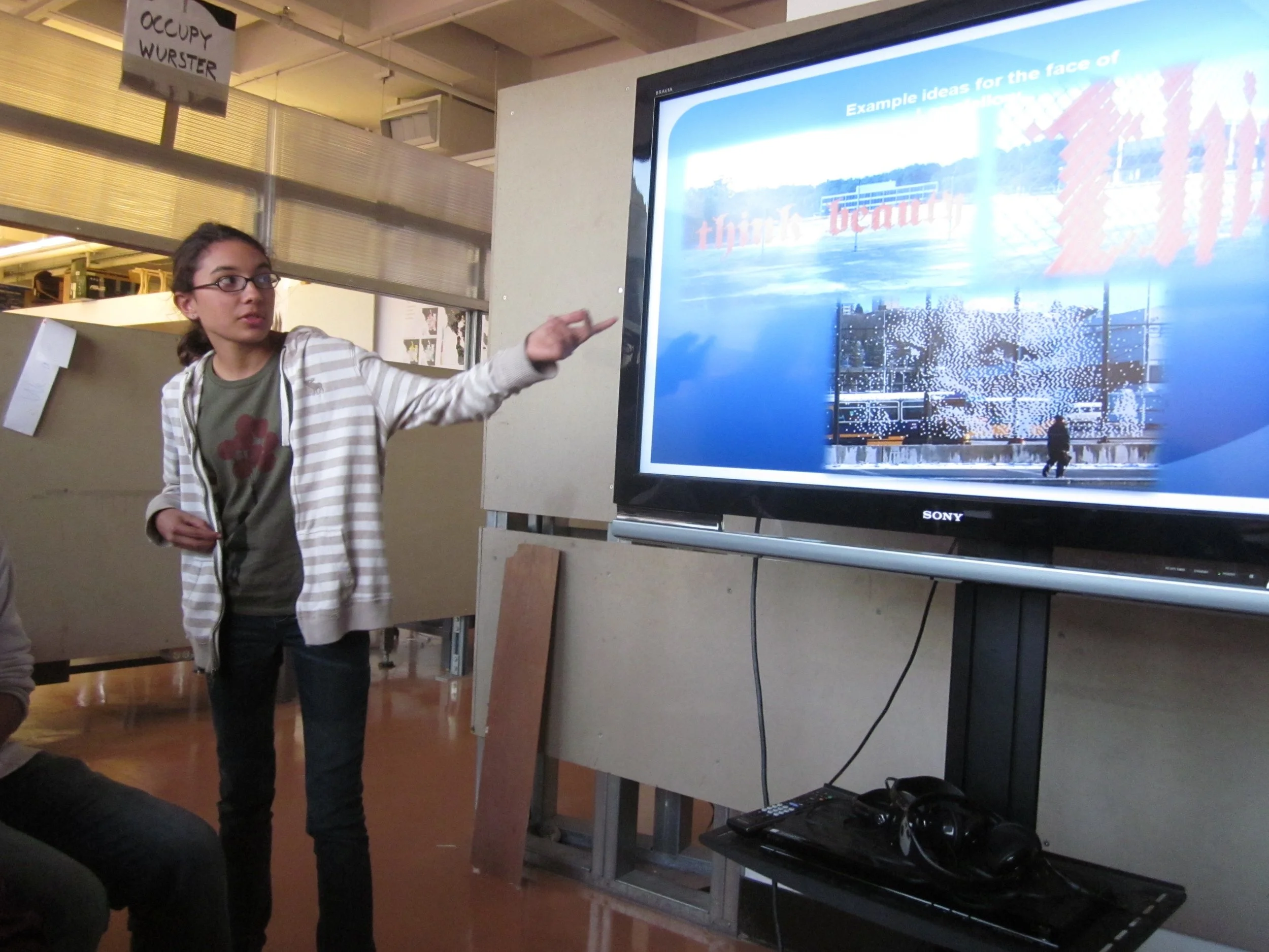 Longfellow middle school student presents to UCB architectural students about their design process to create signage that give their school a public presence