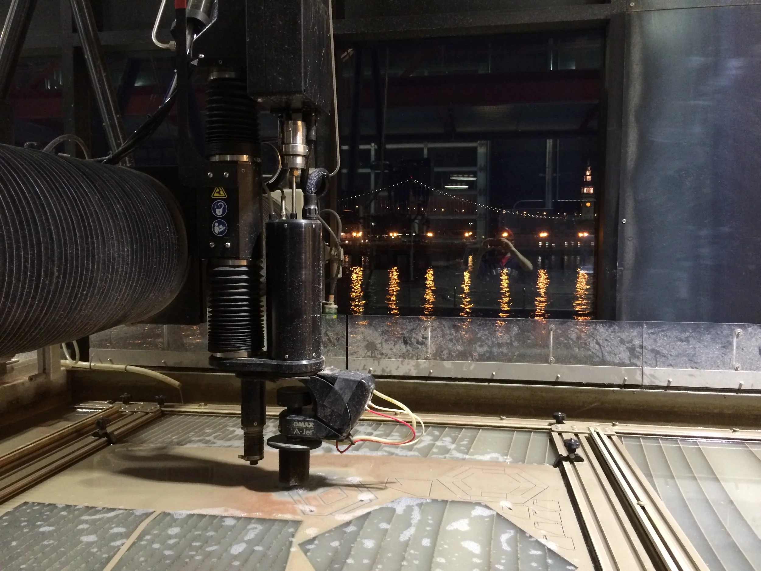 Pier 9 water jet cutting of metal facade prototypes for studio reseach