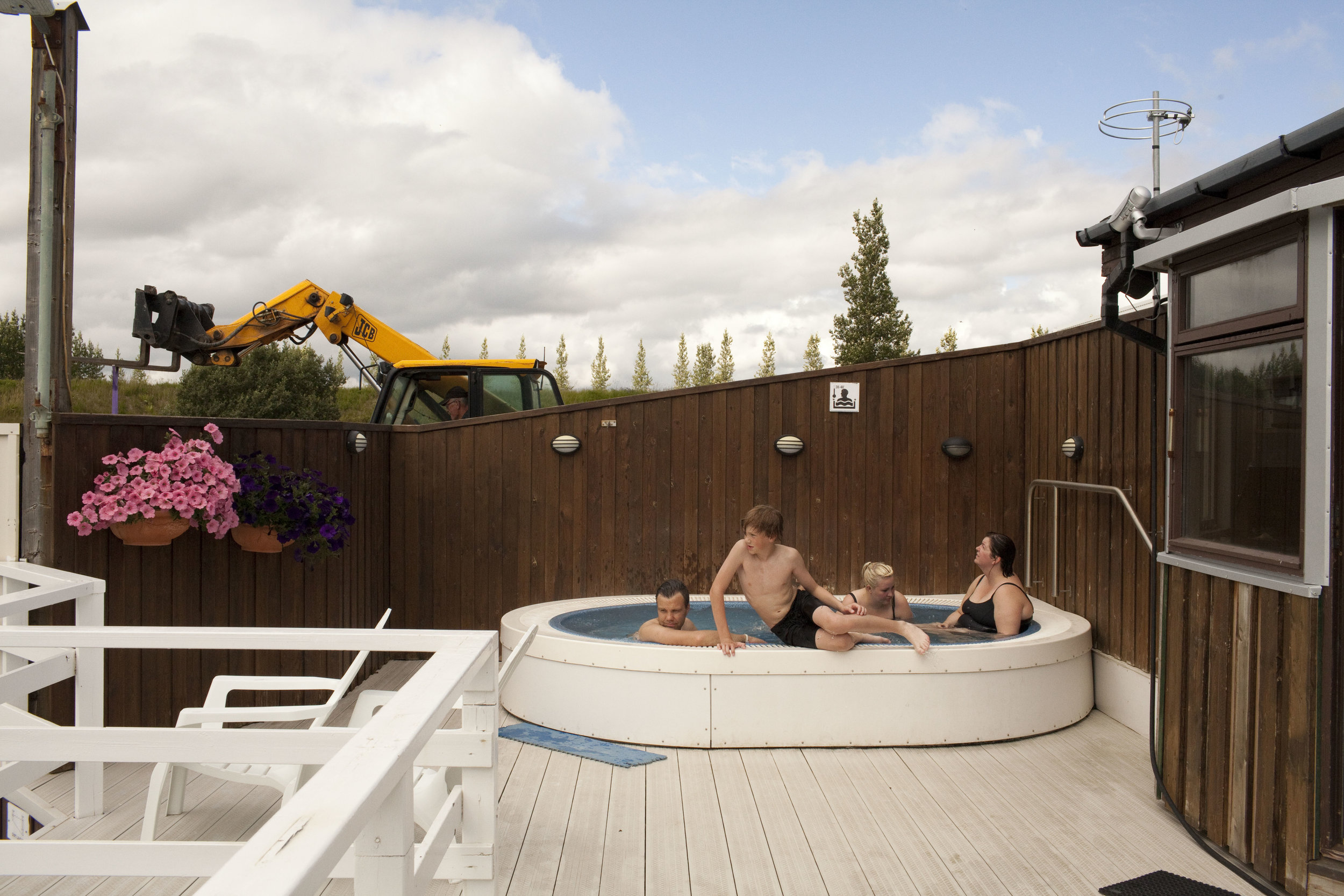 A family soaks in the hot tub at a pool in Fludir, a small Icelandic town of around 400 people.