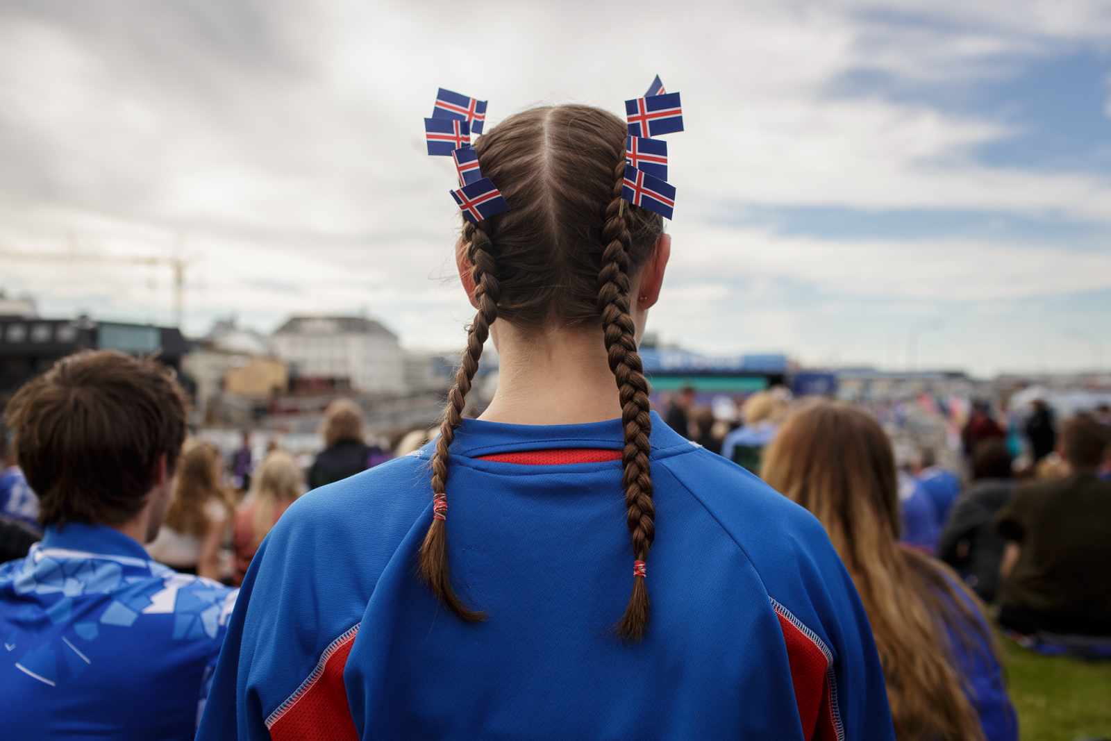 A girl wears braids adorned with Iceland's flag as she watches the Euro Cup 2016 match between Iceland and France on a big screen in downtown Reykjavik.