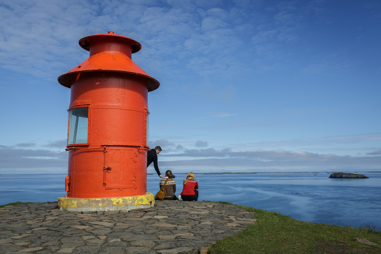 A lighthouse seems to stand at the edge of the world in Stykkishólmur, on the western coast of Iceland in the Snæfellsnes peninsula.